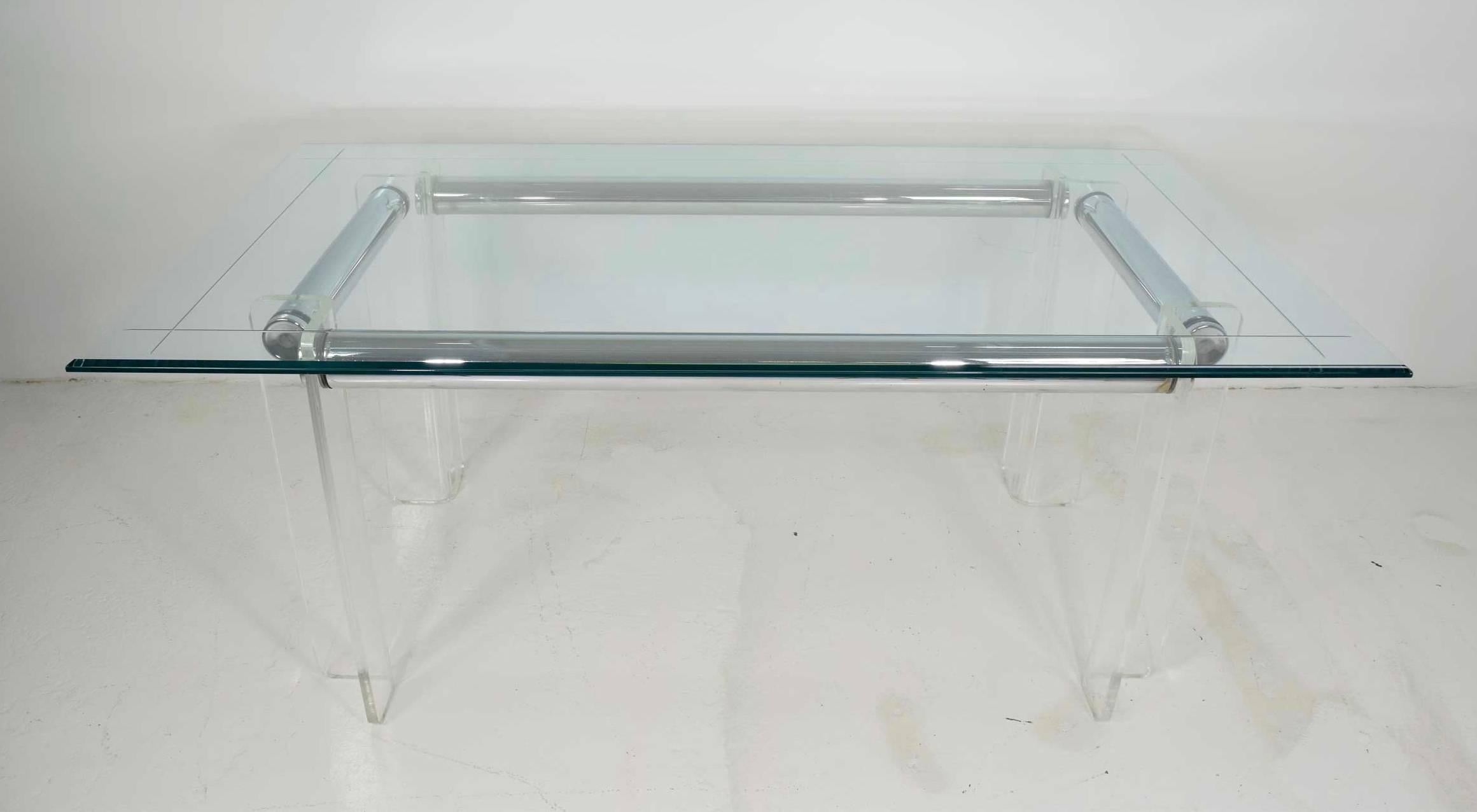 Chrome rods and Lucite legs. The table can accommodate different glass sizes. The measurements we have listed are for the base only and the price is for the base only. We can supply glass as requested. Glass size shown is 72" x 40".