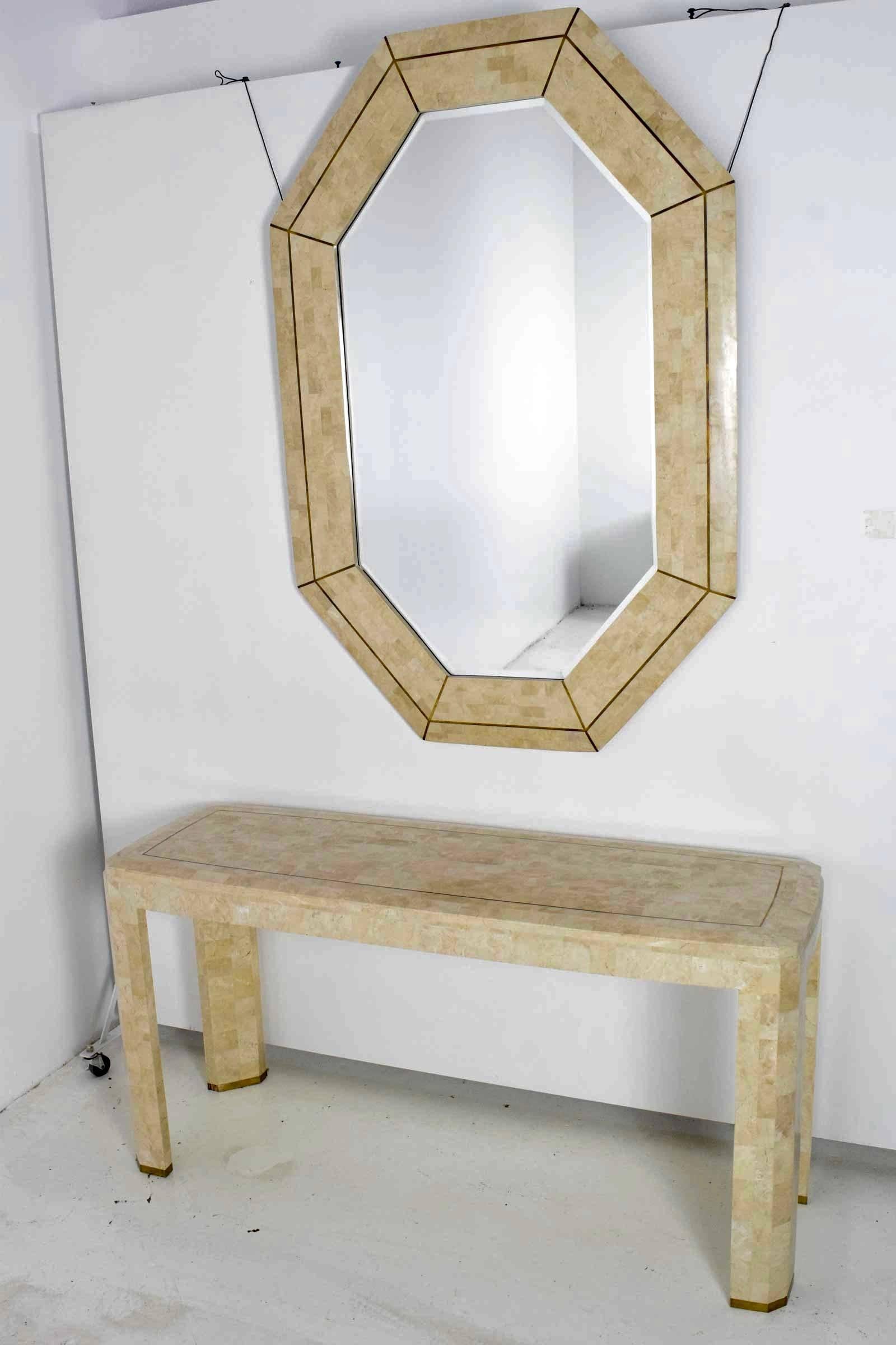 An octagon shaped mirror by Maitland Smith. Brass inlay. We have a matching console available. Please see pictures.