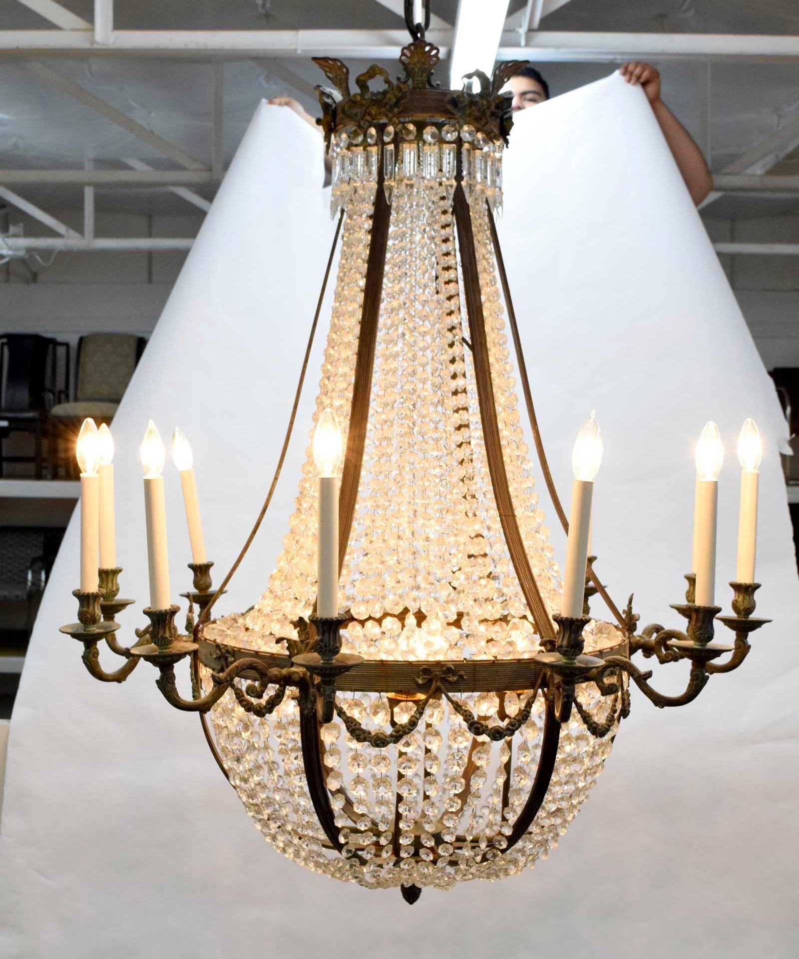 An exceptionally large tent, bag beaded and swagged chandelier in the Empire style. Chandelier has 12 ormolu arms radiating from a circular body suspending a graduated beaded bag which terminates in a hollow hub with ribbon detail. Four bulbs