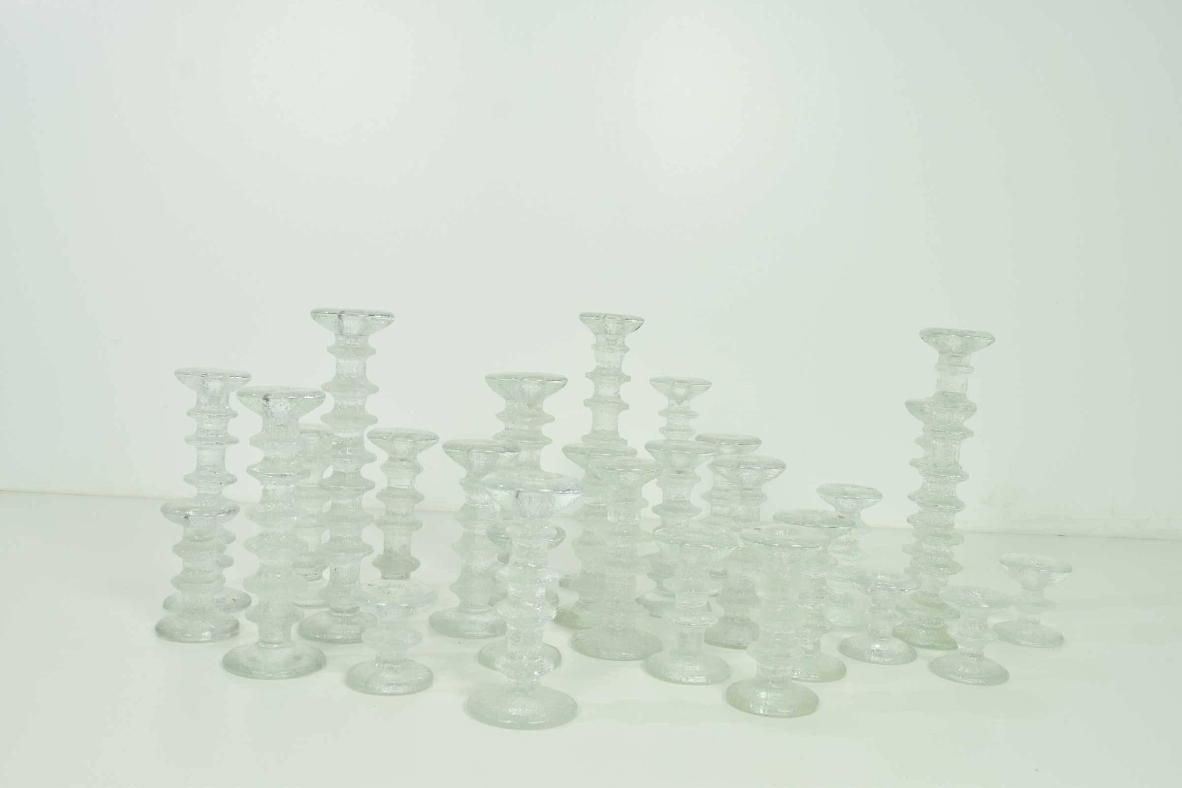 Beautiful on a tabletop, console or coffee table. Large grouping of Timo Sarpaneva candlesticks. Three-eight ring, six-six ring, nine-four ring, three-three ring, three-two ring, six-one ring. Measurement is for the tallest candlestick. They vary in
