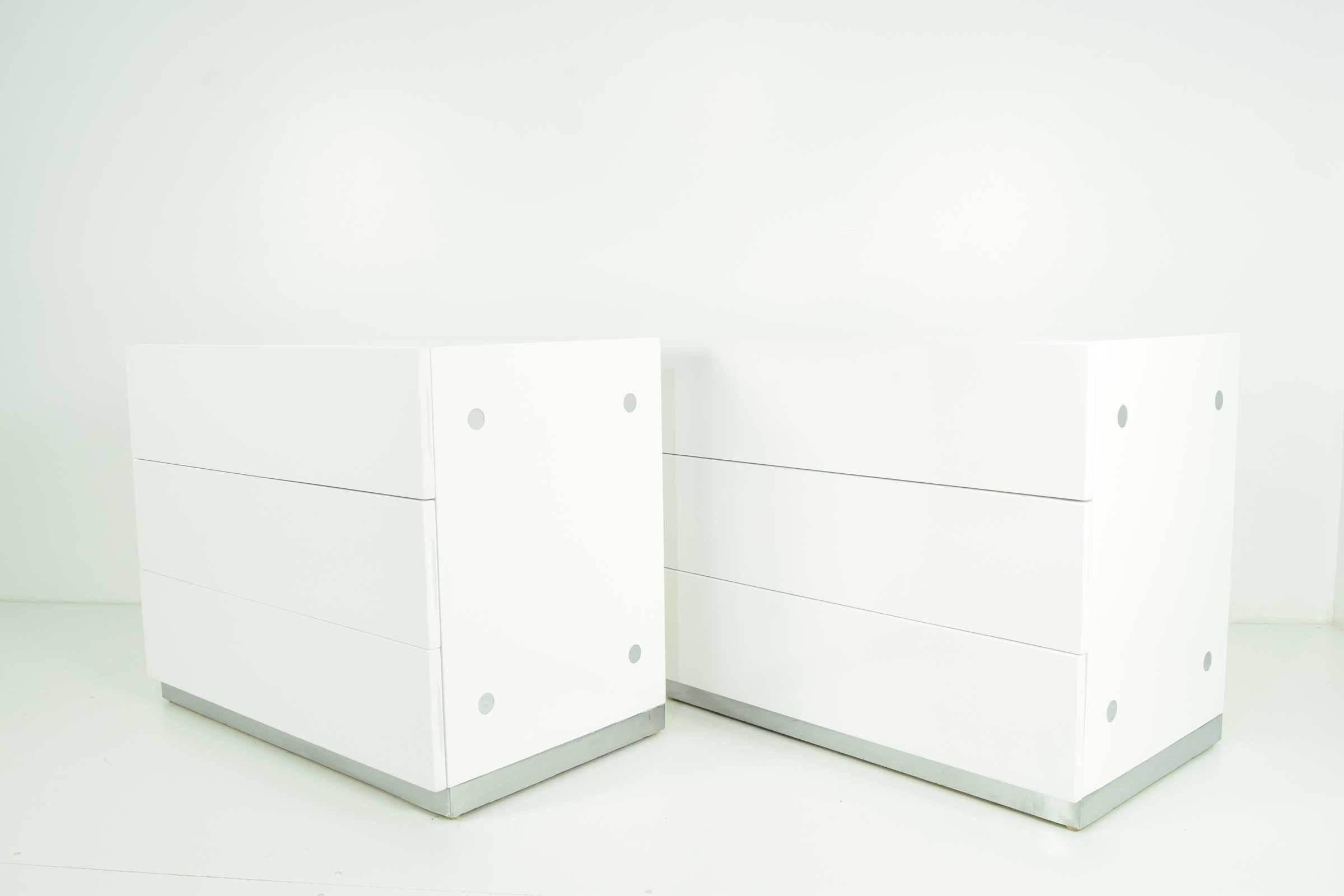 Beautifully restored, pair of white lacquer nightstands/chests by Milo Baughman for Thayer Coggin. Chest have three drawers each and chrome detailing on sides along with chrome trim base.