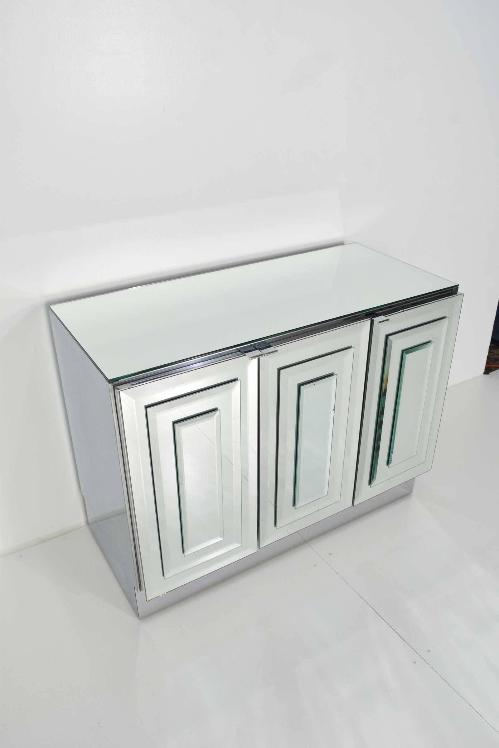 A really nice three-door chest, side table by Ello. Mirrored front and top, chrome sides and base.