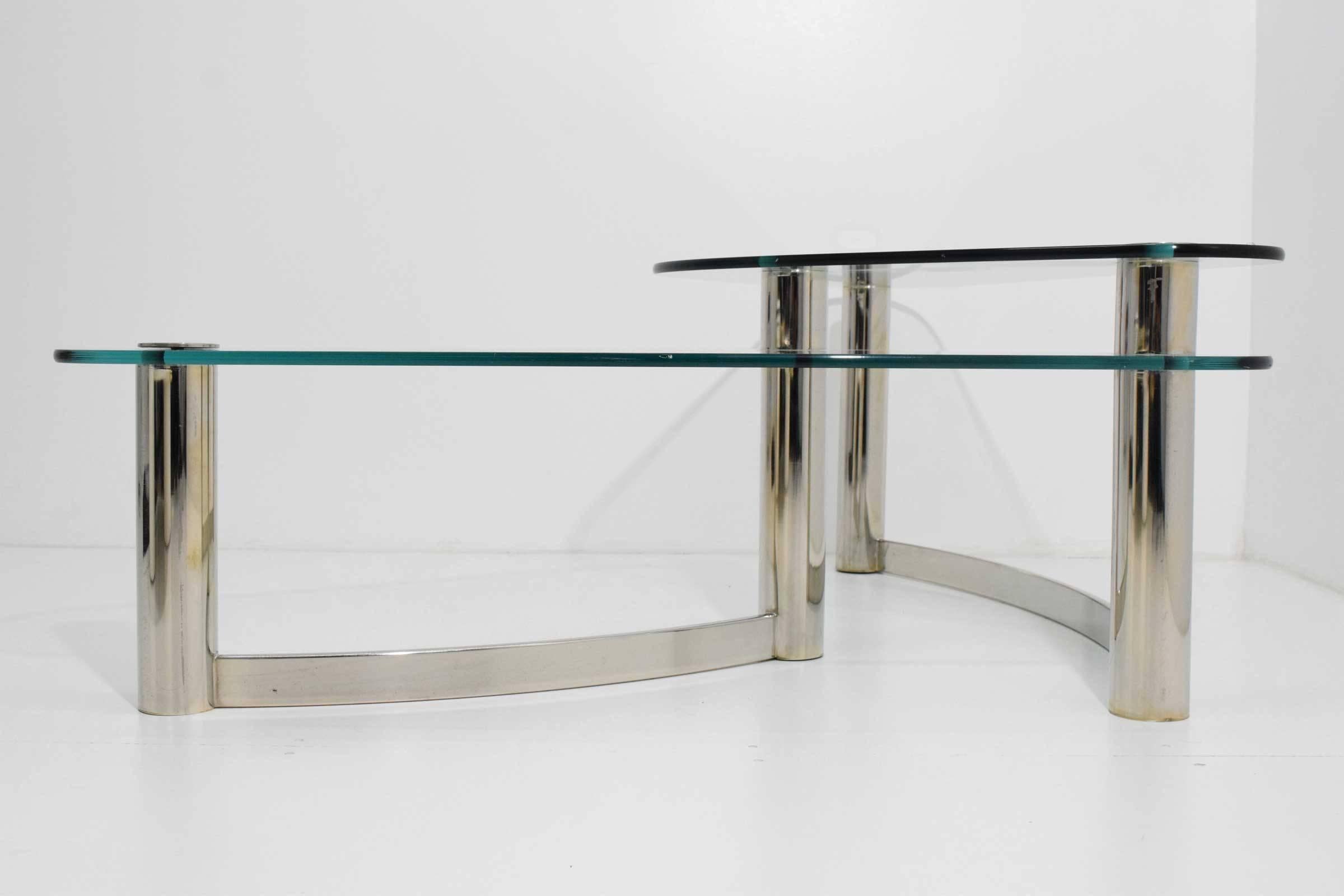 Elegant free style two-tier coffee table with polished metal base and glass tops. Very well made.