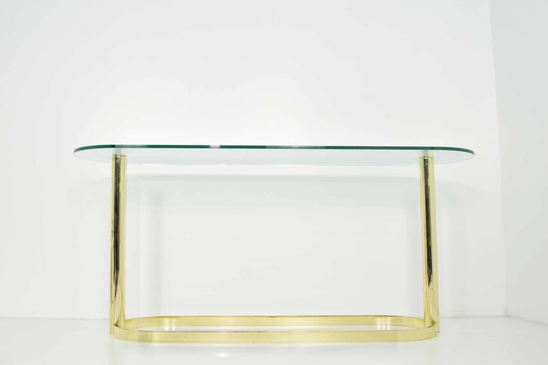 Elegant console in brass finish and glass top by Pace. Very well made. Brass finish is shiny and shows very nicely.