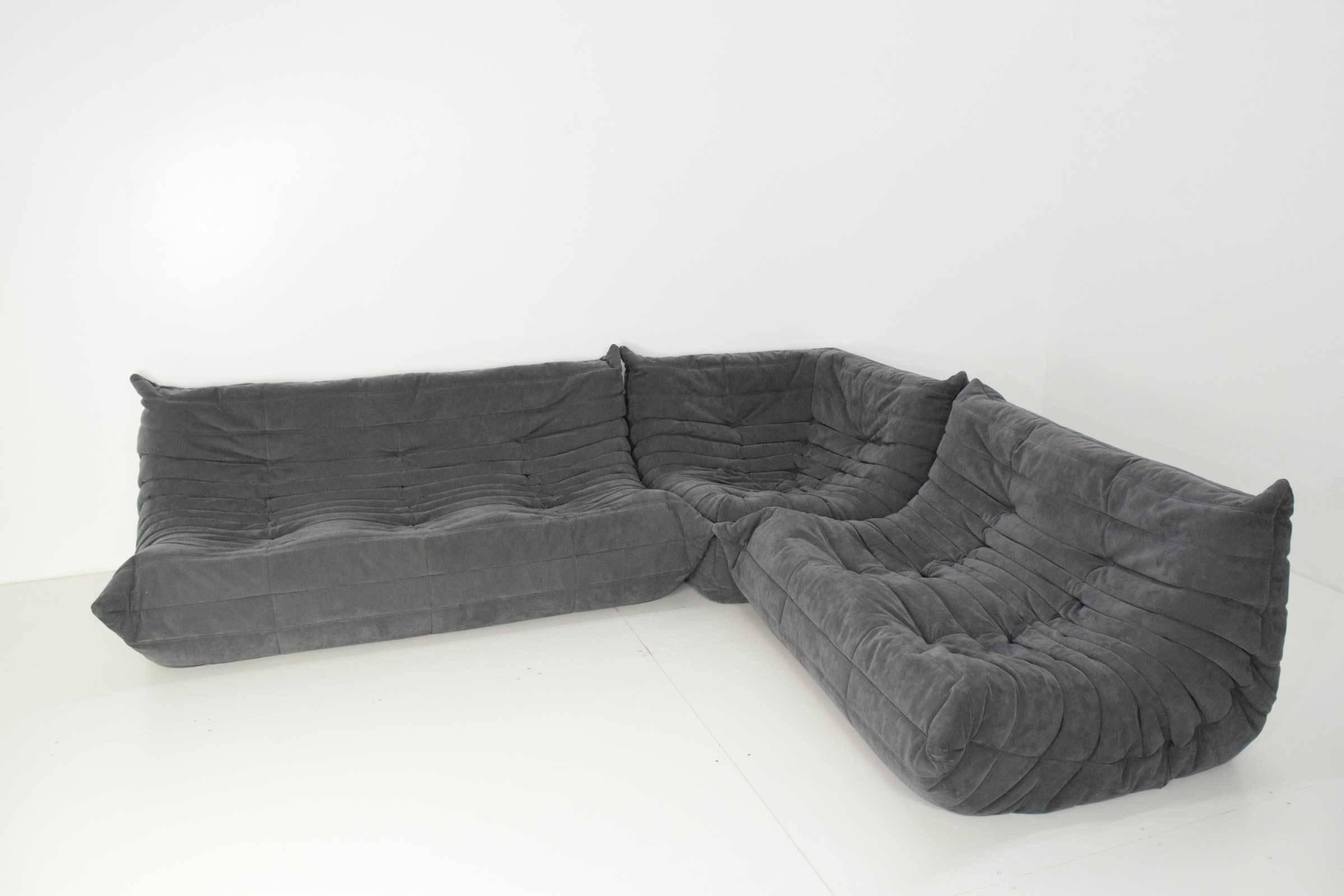 Practically brand new condition. Three piece Togo sofa in a beautiful grey suede. This sofa is super comfortable. A Ligne Roset classic, Michel Ducaroy’s Togo has been the ultimate in comfort and style for over forty years. The timeless collection