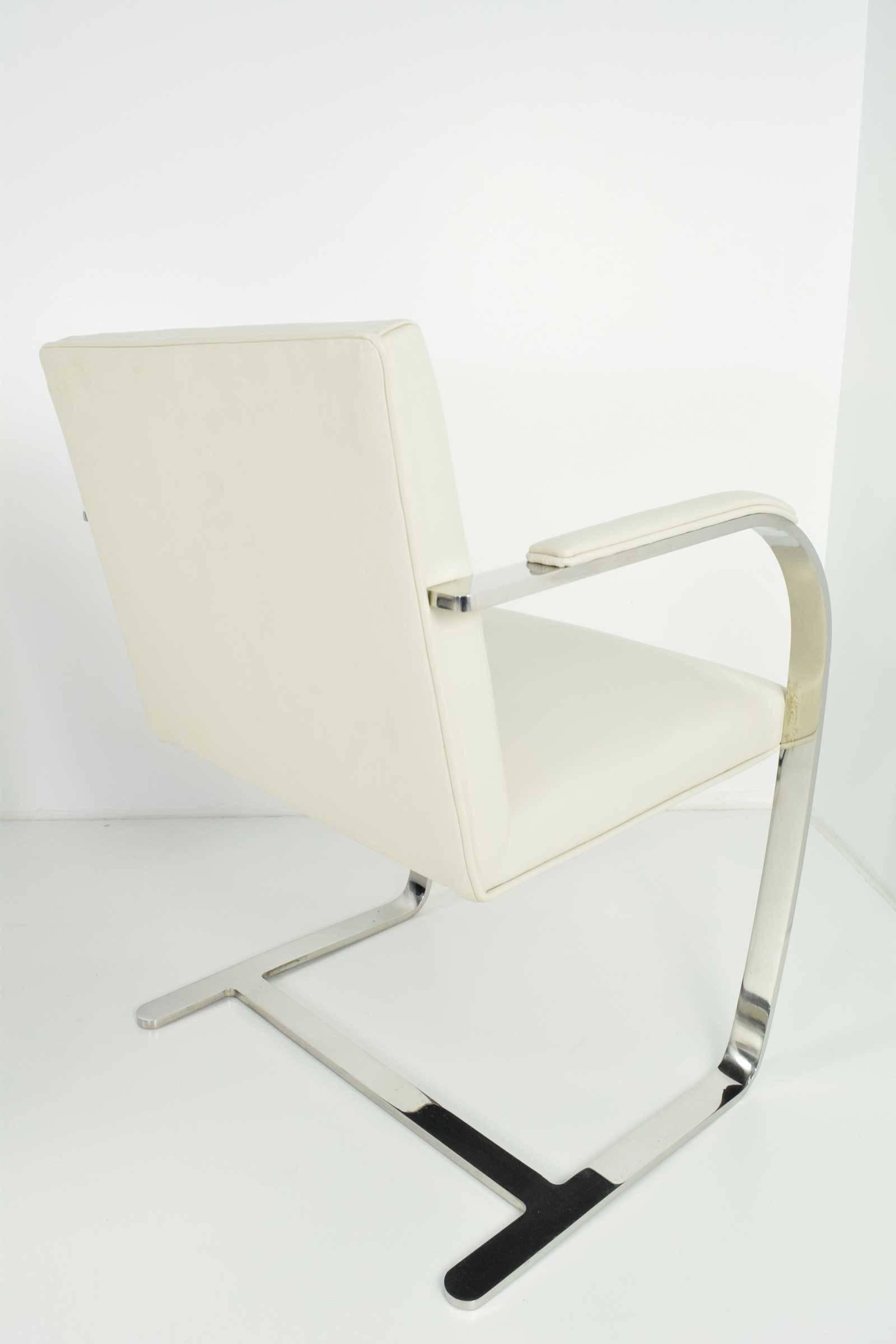 This is a set of four flat bar Brno chairs by Mies van der Rohe for Knoll. Chairs have practically brand new leather upholstery in a light grey and include arm pads. Provenance: An important estate in Connecticut designed and decorated by Warren