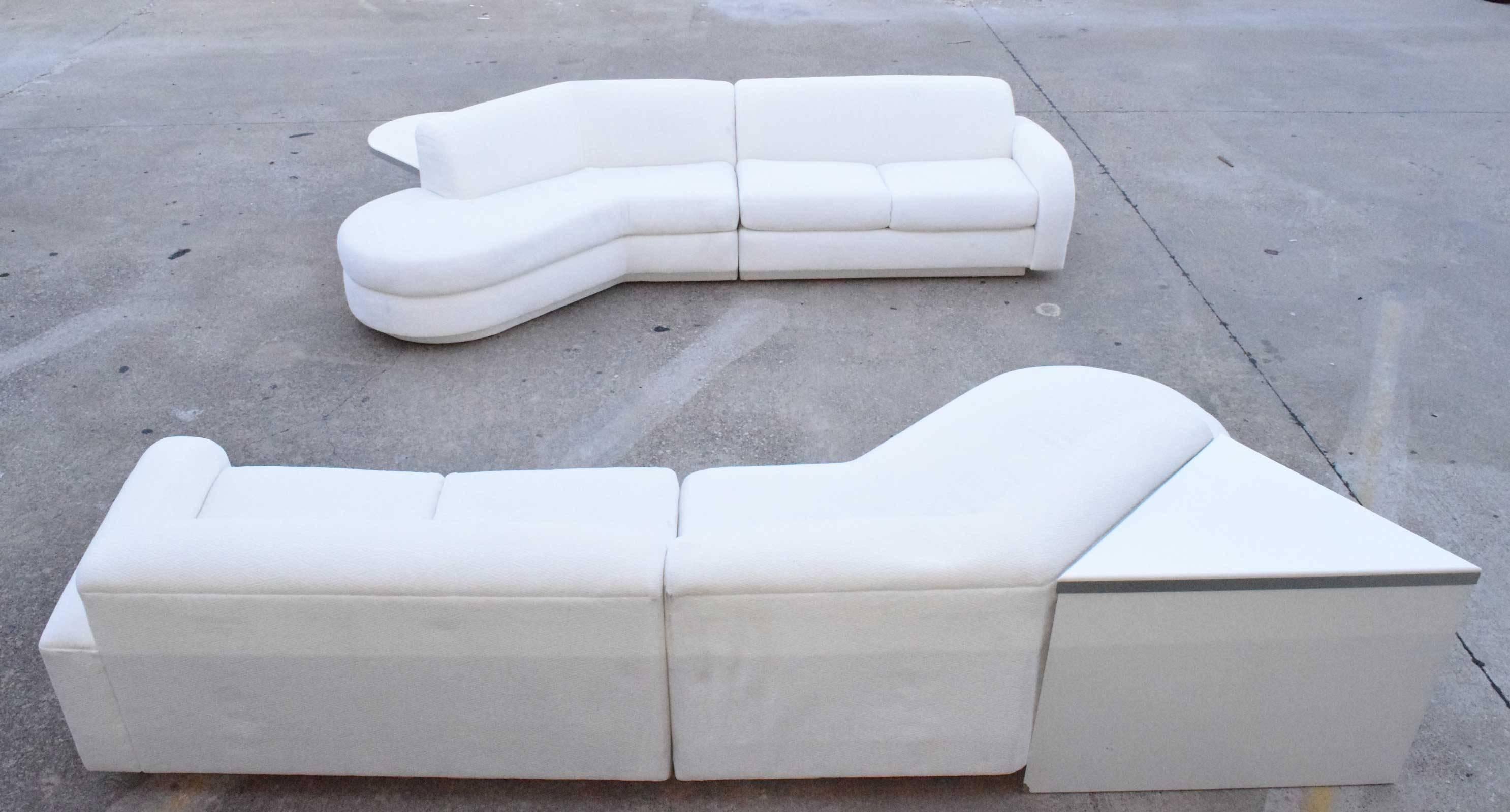 A beautiful pair of matching sofas by Vladimir Kagan for Directional. The sofas are done in a white textured fabric. The tables are not attached but butt up to sofas as desired.