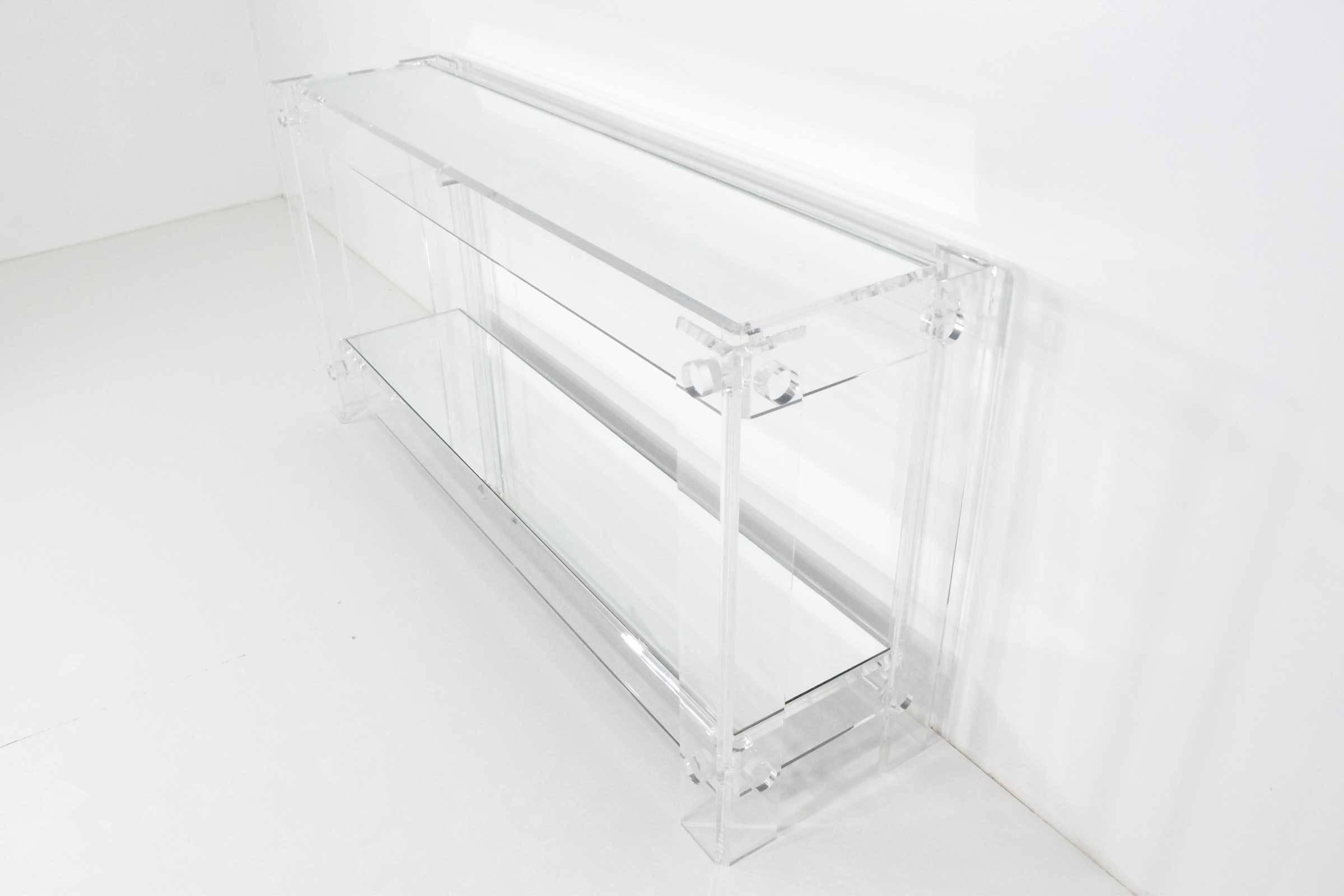 Beautiful Lucite console table with mirrored top and bottom.