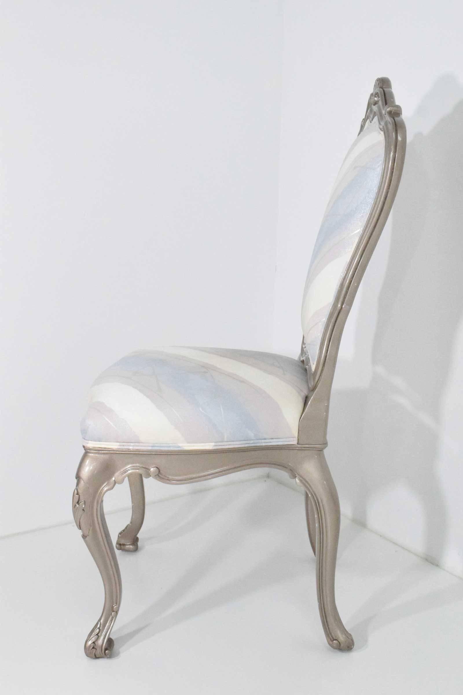 Louis XVI style dining chairs done in a high-gloss platinum lacquer. We have six chairs and can expand to eight by repairing legs on two of the chairs. These are super glossy!!