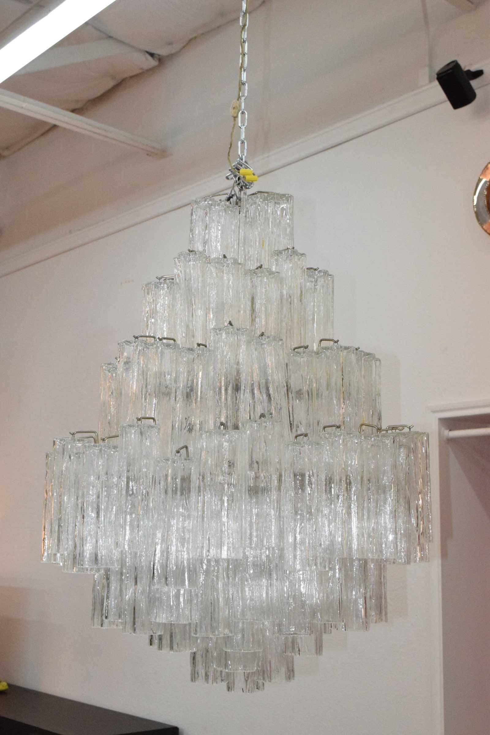 Chandelier has eight layers, 12 light sockets (not all lit in photograph), all crystals are present. Measures: 40