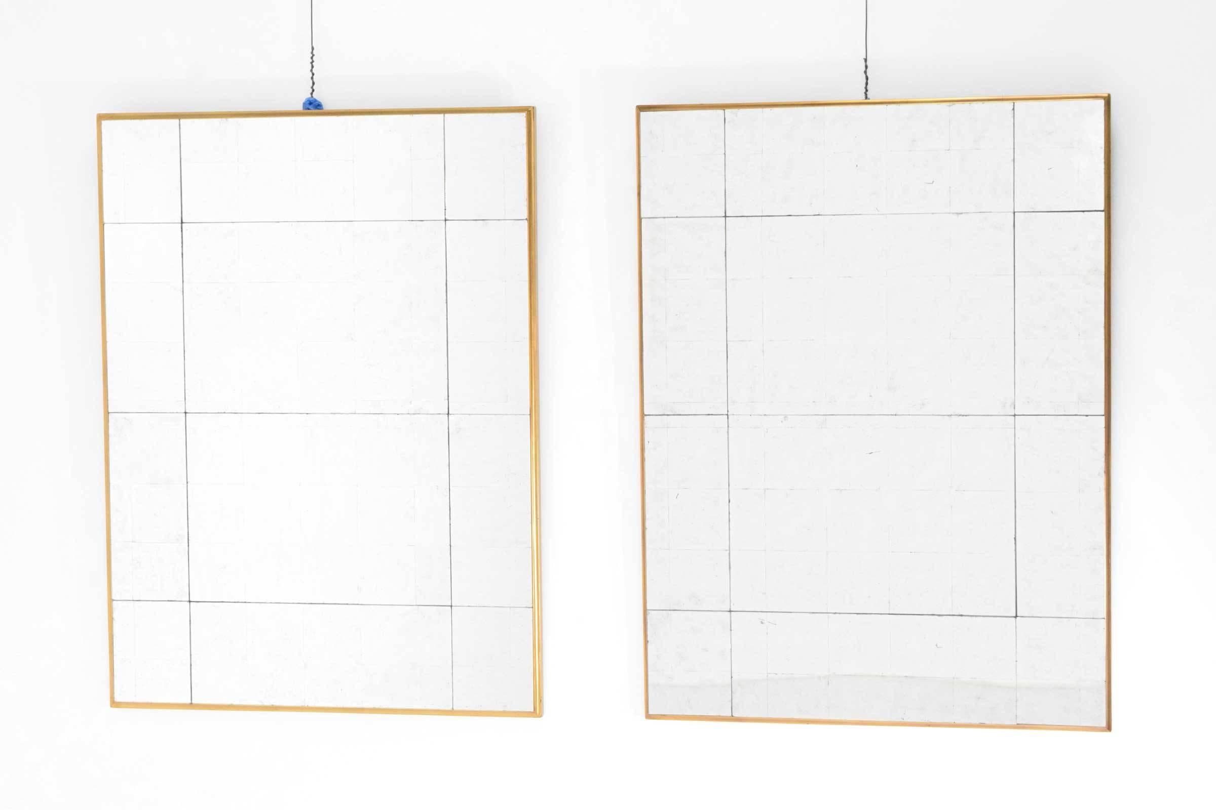 Antiqued mirrors on gold finish frames.