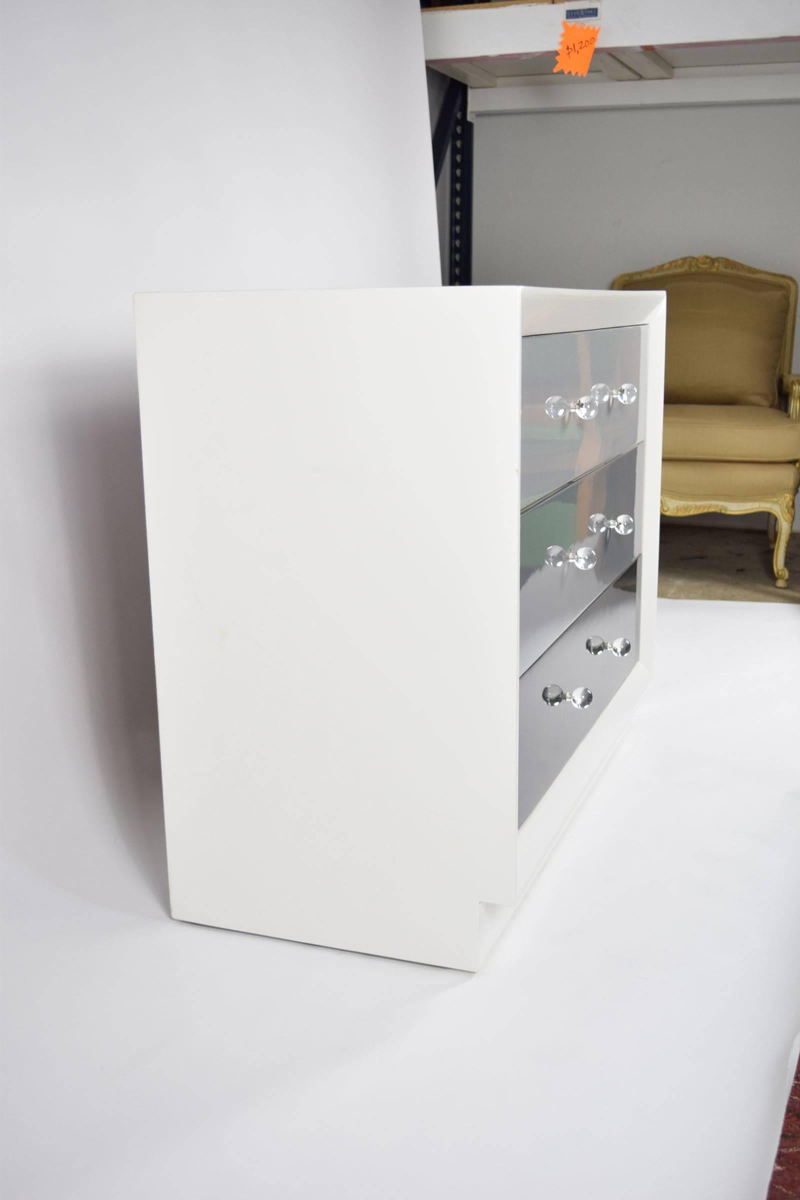 Pair of chests by John Staurt in new lacquer. Colors are white and tones of grey with Lucite/acrylic knobs.