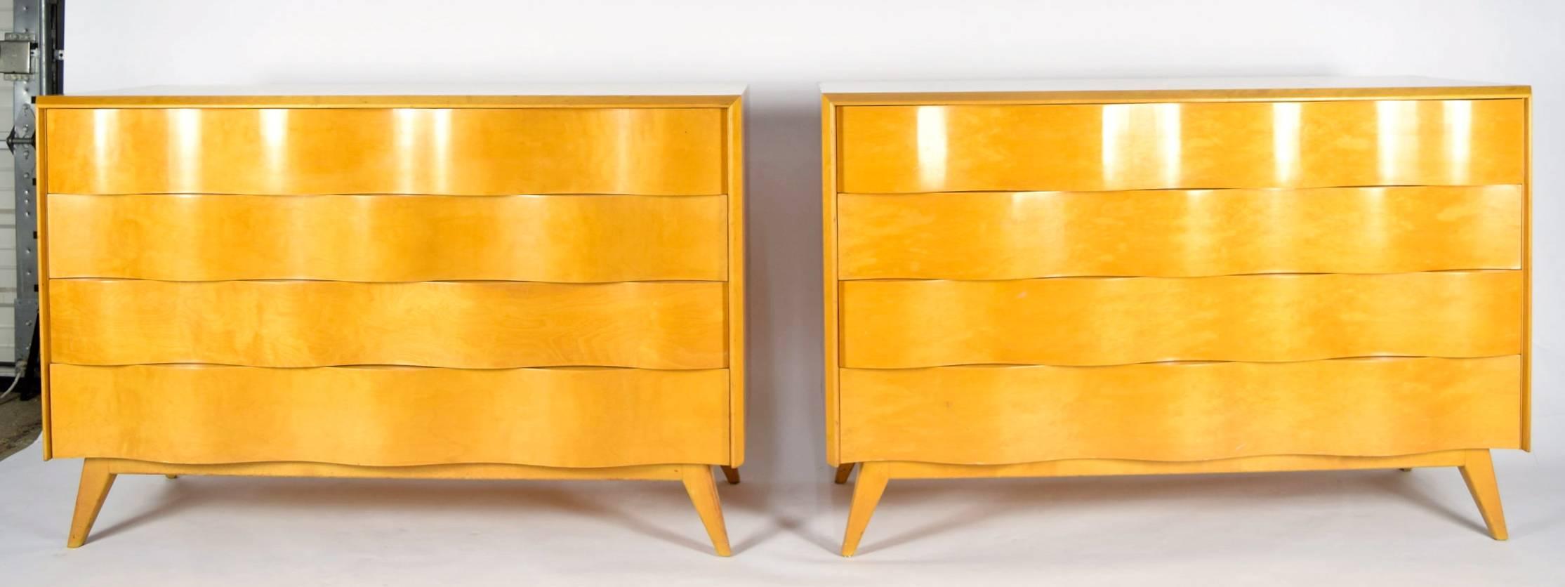 Beautiful pair of chests by Edmond Spence. Gorgeous wavy front with four drawers each and plenty of storage. We are able to lacquer these in any color desired or leave in their natural finish.
