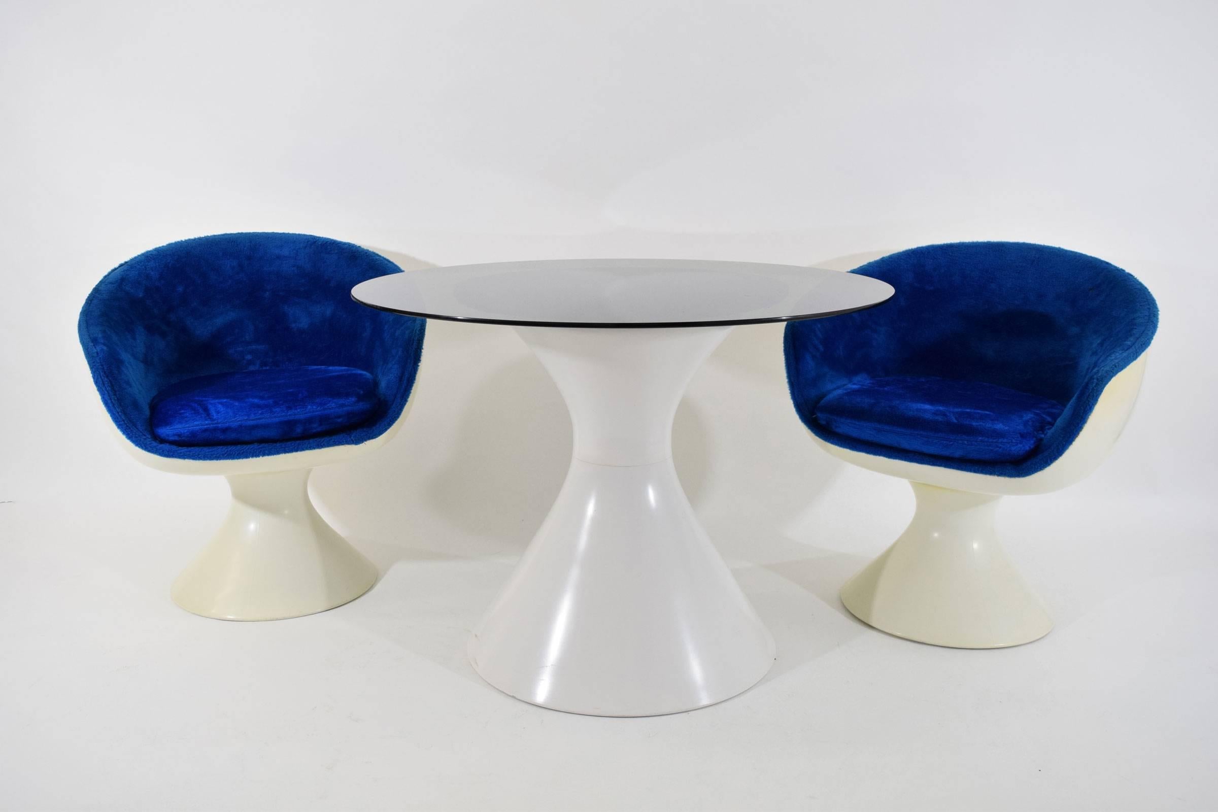 Fiberglass table with glass top. Size of top can be adjusted. We have a set of four chairs that go with this table.