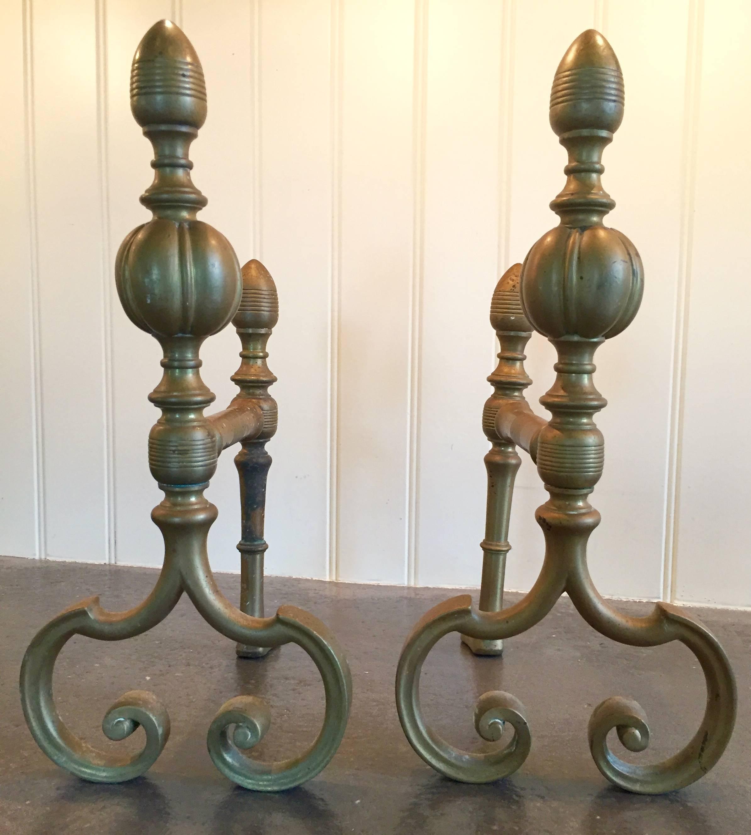 These petite brass andirons are actually fireplace tool holders (see last photo), but could of course function as decorative andirons.
They most likely date from the 1800s, though the scrolled base is reminiscent of designs invented during the