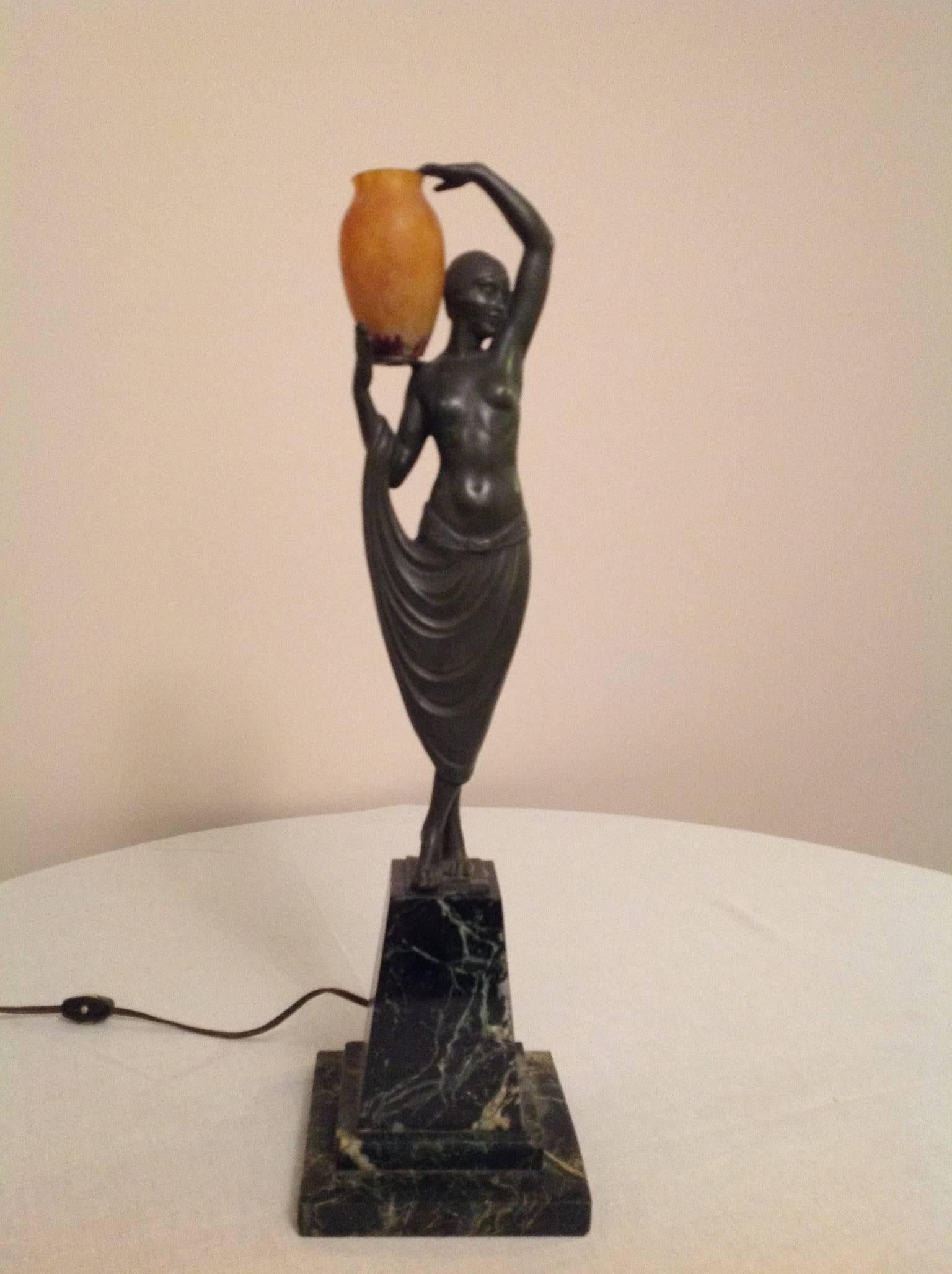 This important and rare Art Deco bronze of a female nude balancing a large urn is by Fayral, a pseudonym for Pierre Le Faguays. The French bronze is patinated and mounted on a black and green-veined marble base. It is signed 
