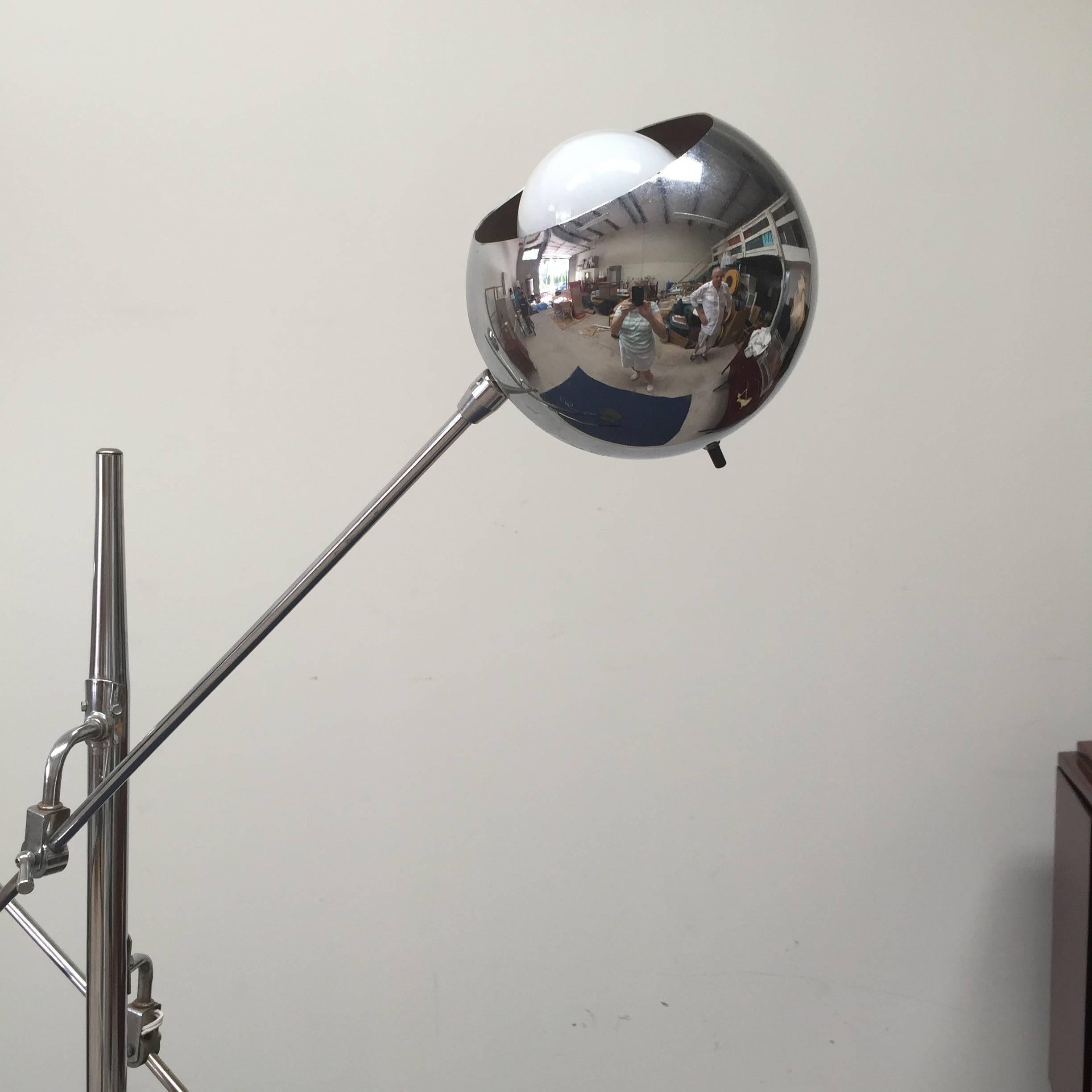 Classic double-armed chrome orbiter tripod floor lamp. Excellent vintage condition, original cord with fully adjustable and articulating heads. Chrome is free from pitting or peeling.