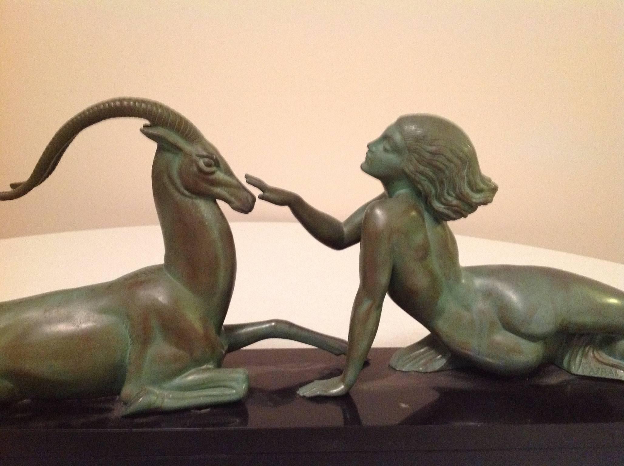 This Art Deco sculpture is French bronze with a black marble base. It shows a female nude petting a gazelle. It is by "Fayral", which was a pseudonym for Pierre Le Faguays.
It has the following signature and marks: Fayral and the Max Le
