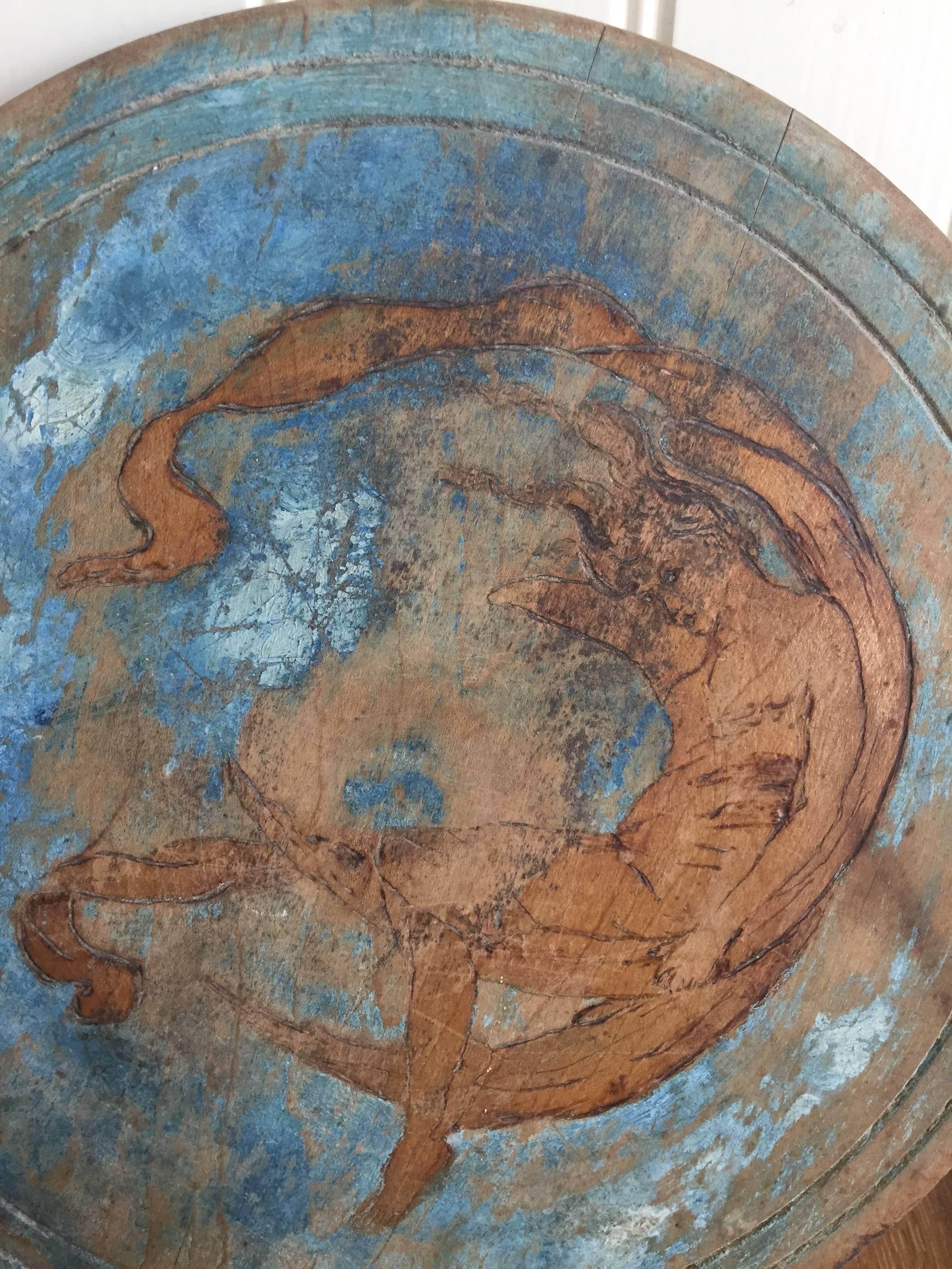 The image on this wooden lid, which conceivably could have been part of a butter or milk churn, has a distinctly Art Nouveau style. If you look at the close up of her face, and the movement of the entire image, it has the sophistication of that