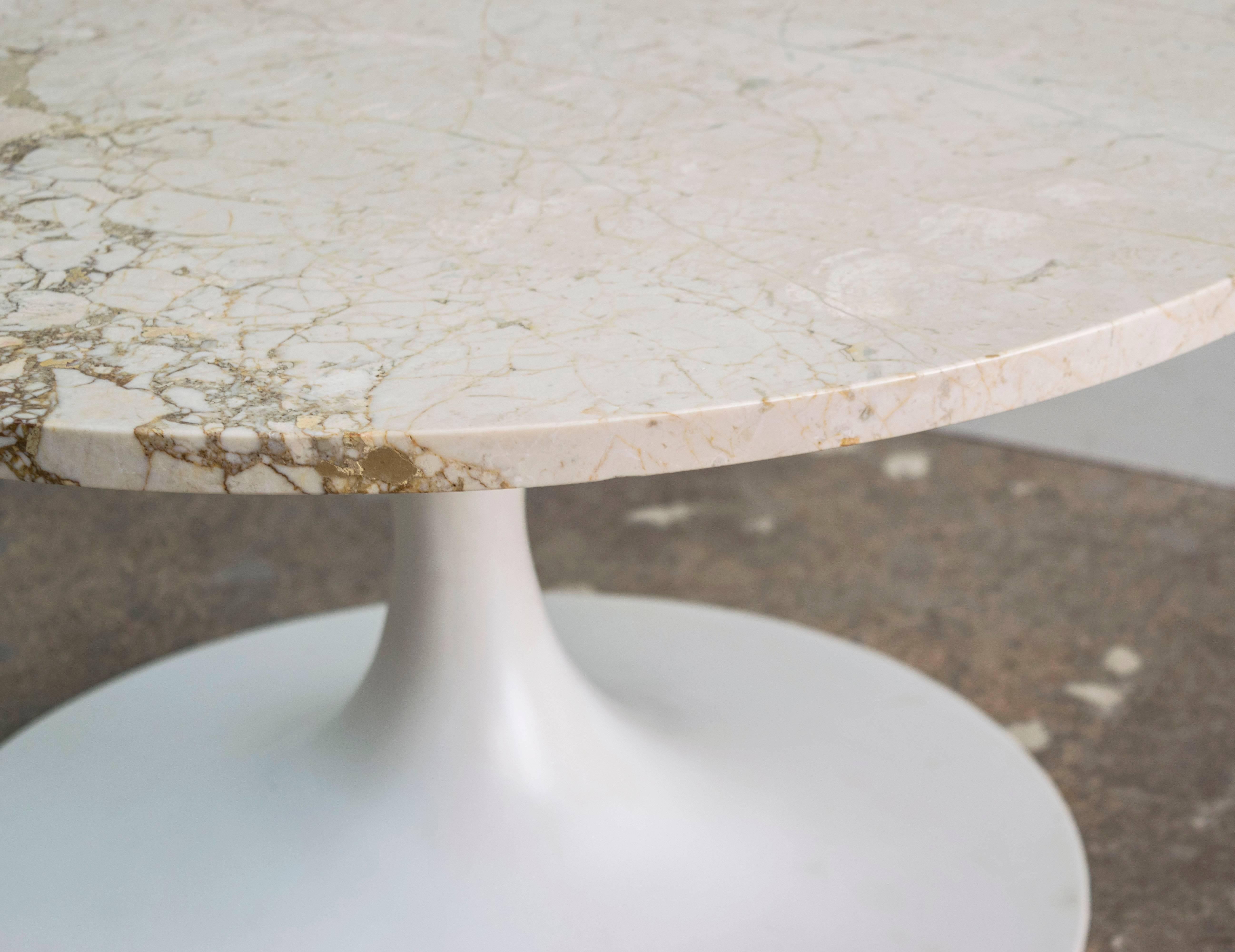 Beautiful 1960s Saarinen tulip coffee table by Burke. Coated aluminum base and travertine top excellent condition and perfect for any interior.