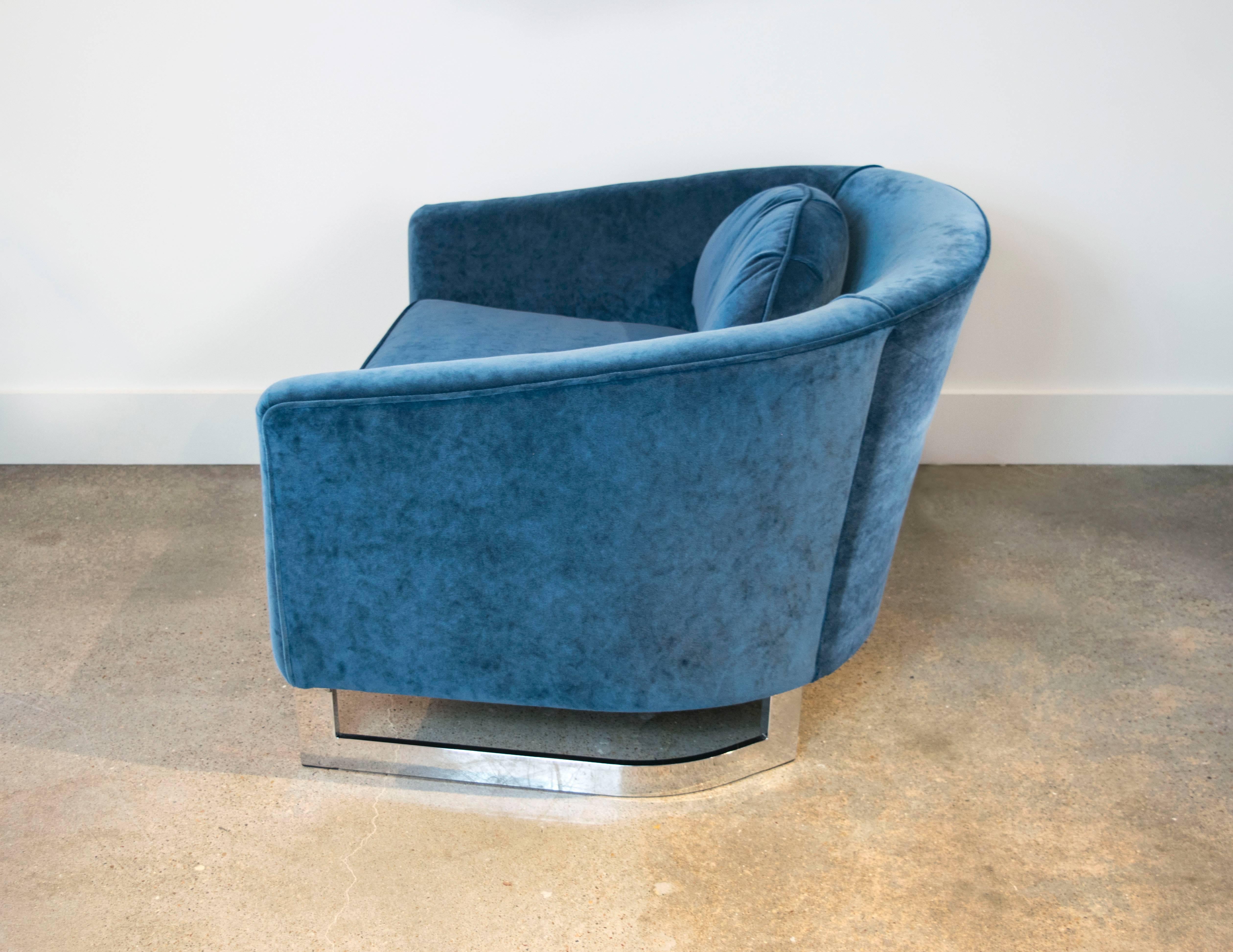This iconic sculptural club chair by Milo Baughman has the curved back and metal base. Expertly recently reupholstered in a Prussian blue velvet.