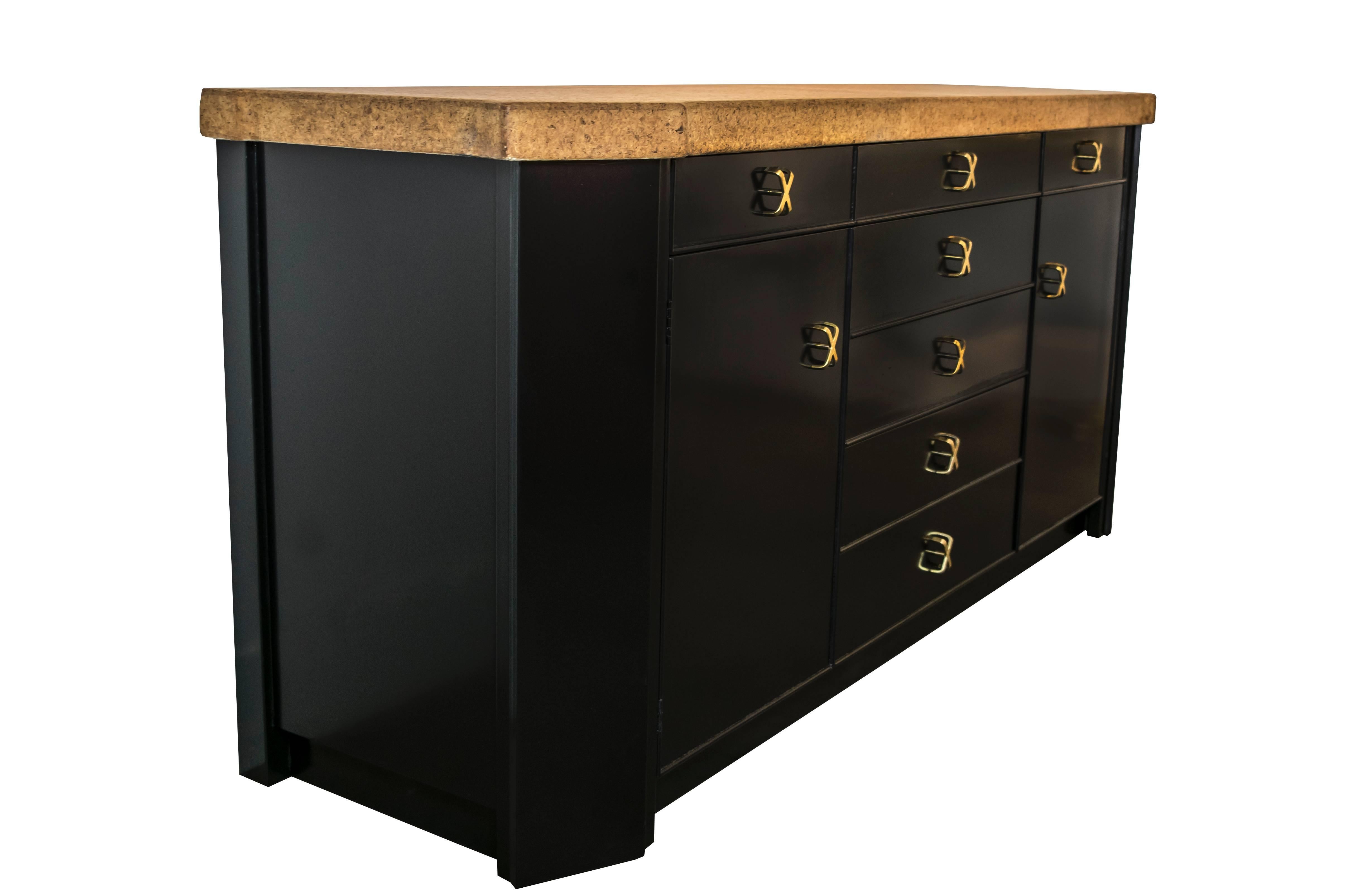 Highly stylized credenza or cabinet designed by Paul Frankl. This cabinet exemplifies Frankl's fine Mid-Century design detailing elegant hardware combining materials such as cork and mahogany with brass accents.