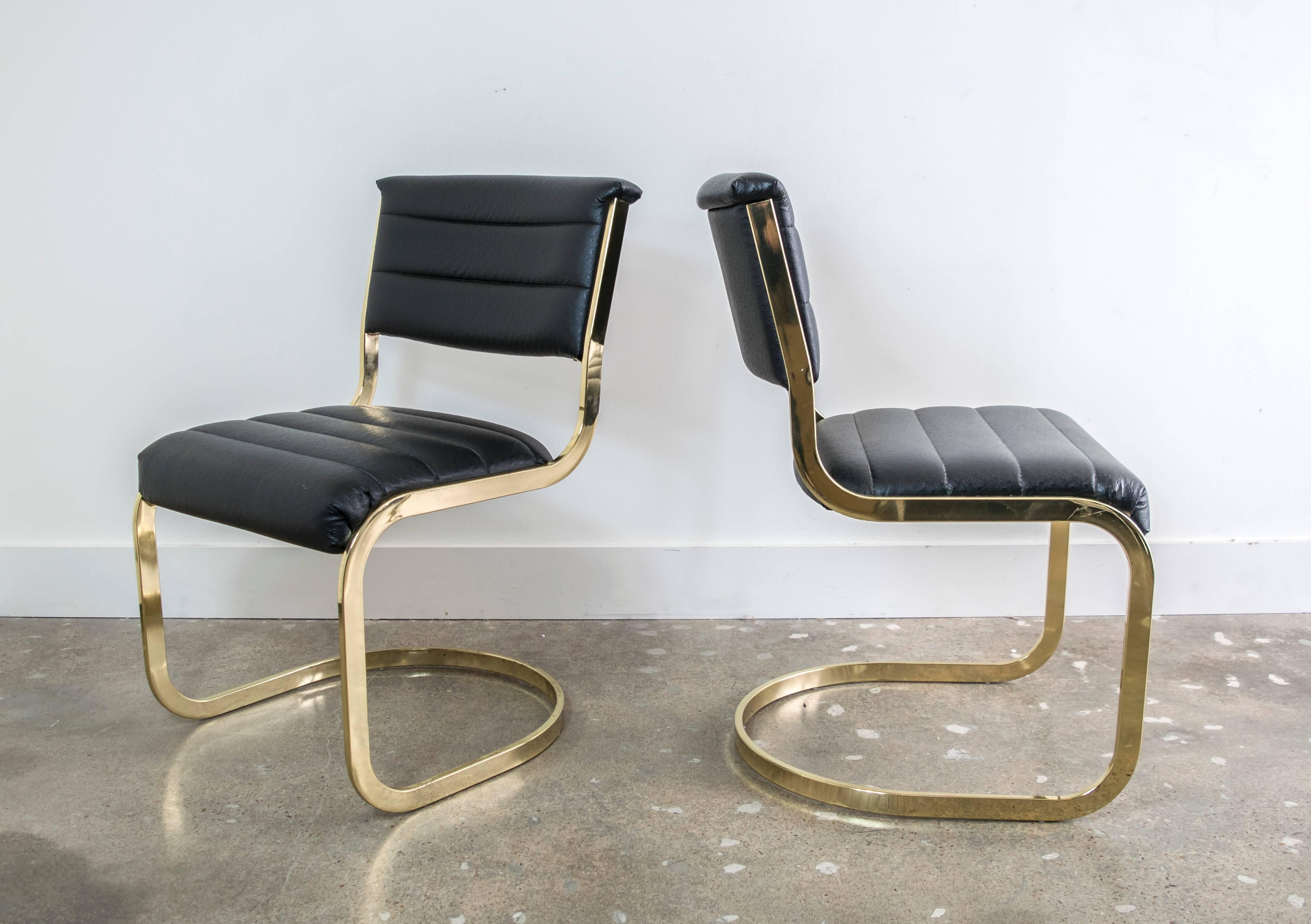 A set of six cantilever brass dining chairs in the style of Milo Baughman. These dining chairs have a stunning profile and are especially attractive from behind.