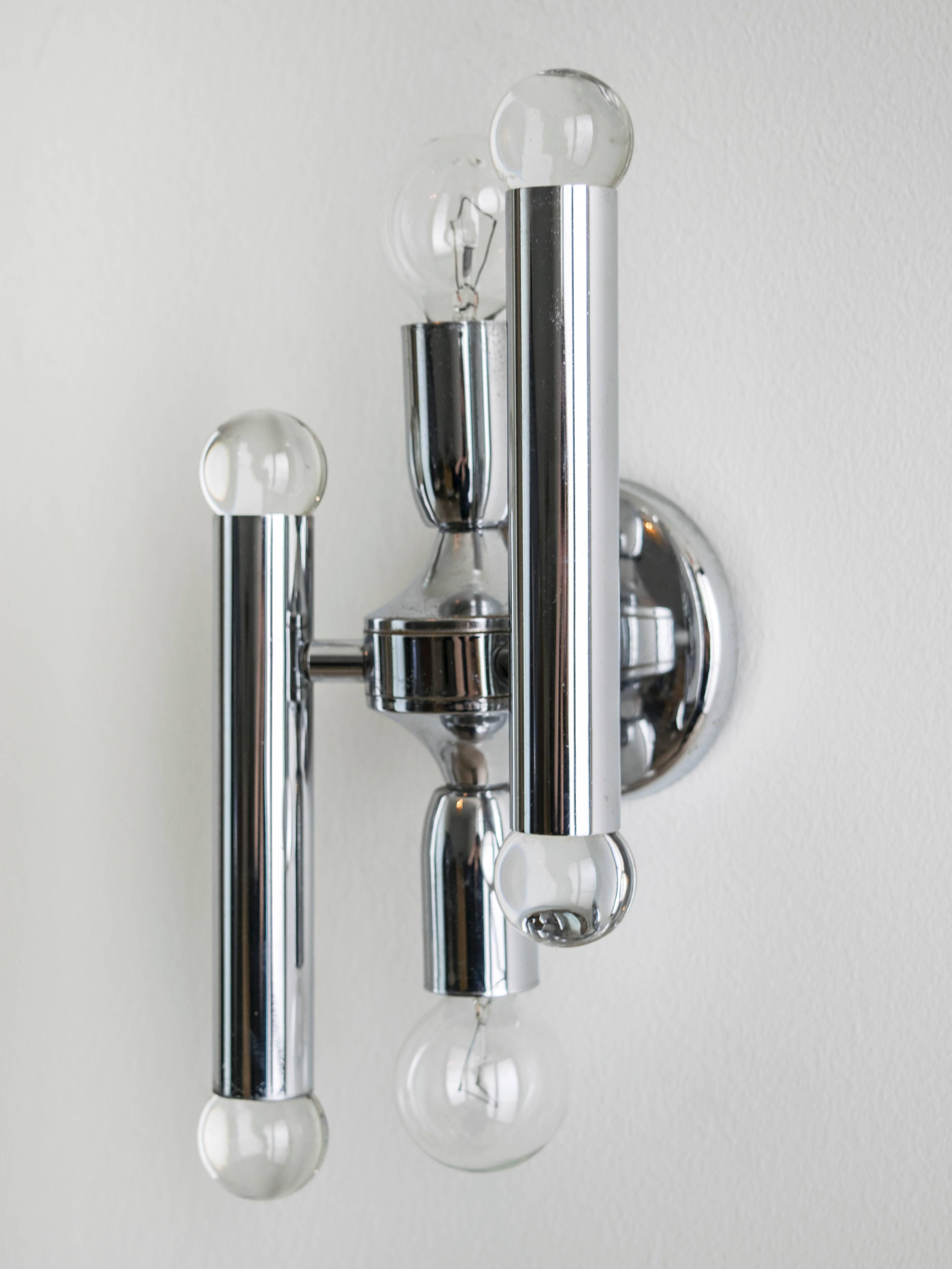 Iconic Sciolari design featuring sconces with baton chrome and crystal end caps with a center light fixture of one up and one down.