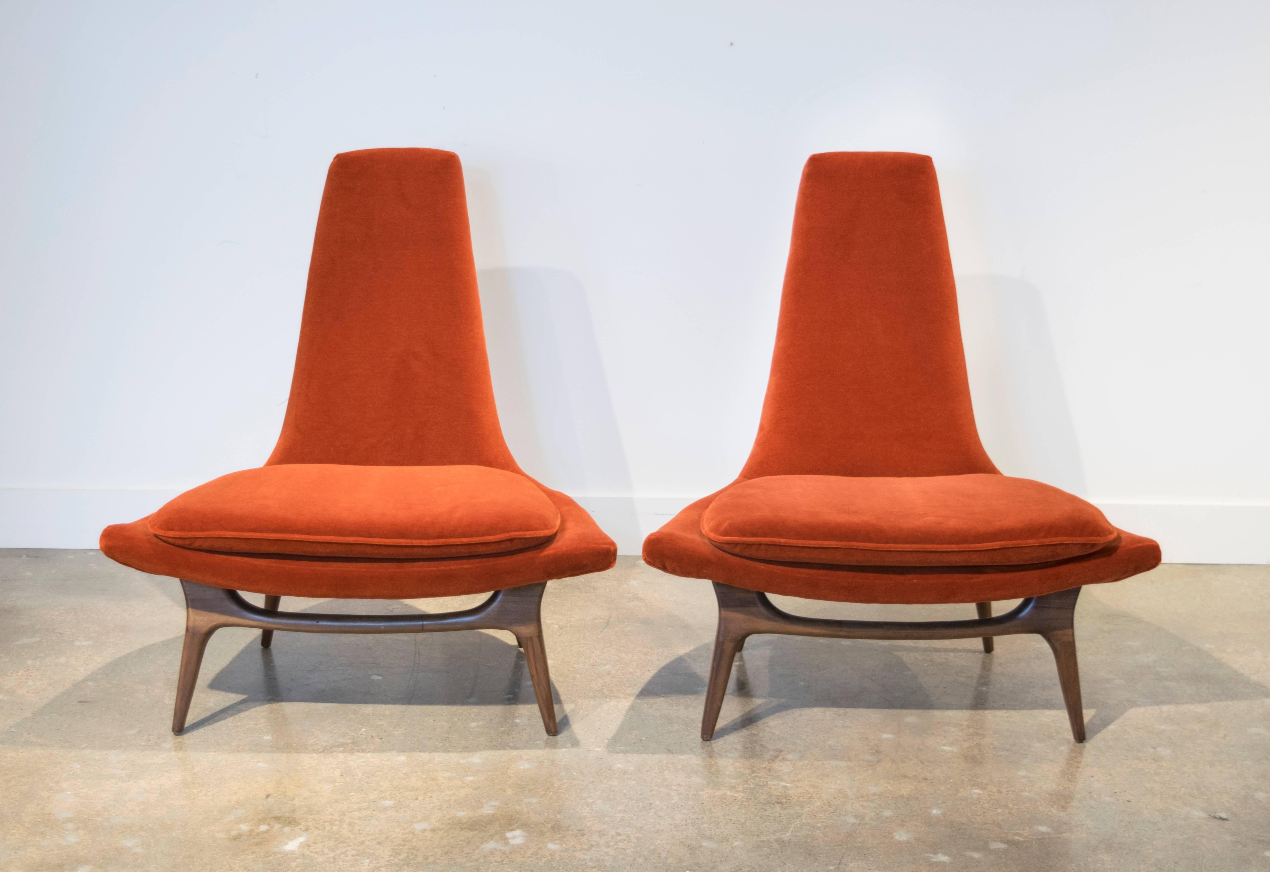 Wildly sculptural pair of lounge chairs by Karpen from the early 1950s. This pair has subtle angle seats and tapered backs with perfectly designed dark walnut stained legs and new Knoll velvet.