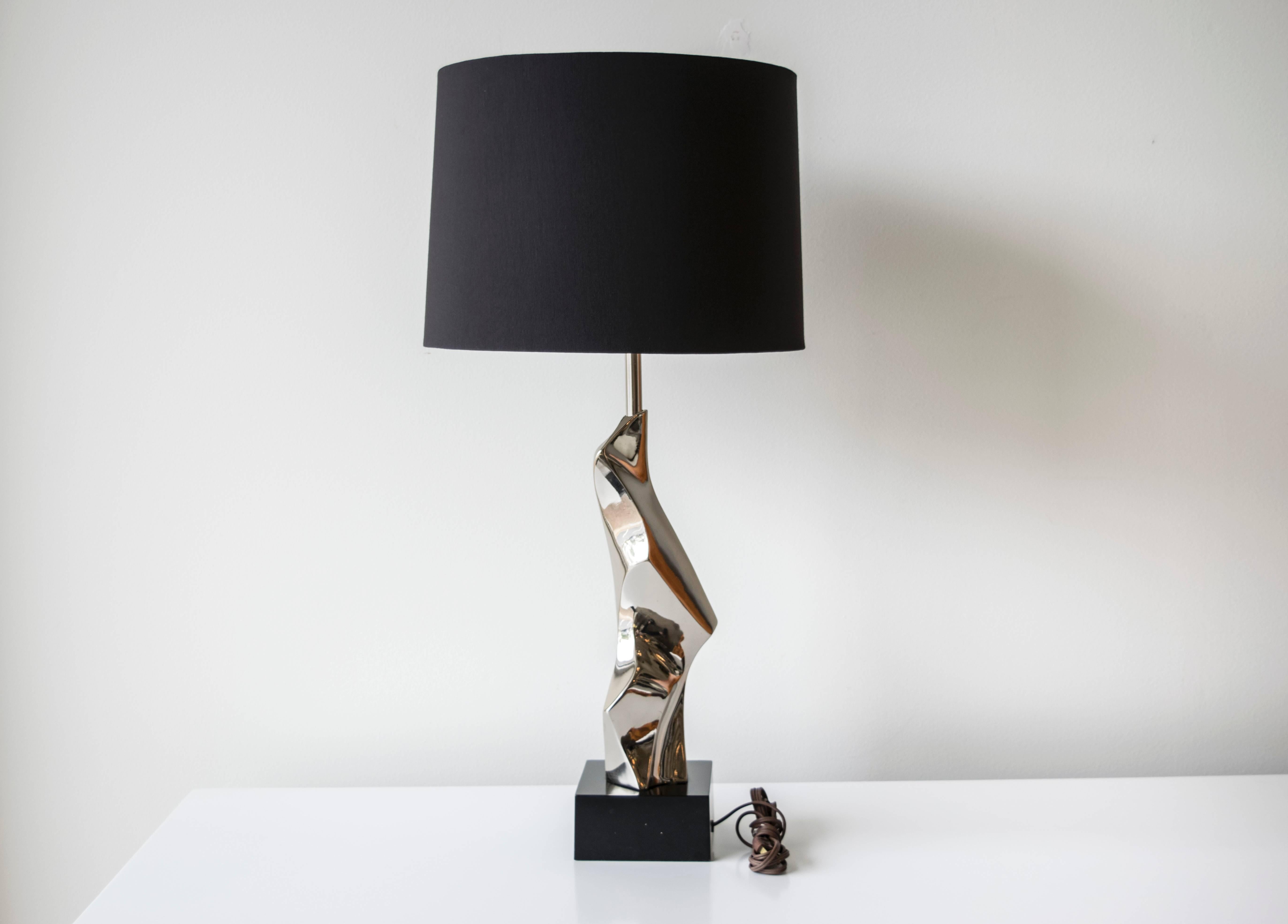 Elegant iconic Brutalist lamp by Maurizio Tempestini on a black lacquered chrome base.
