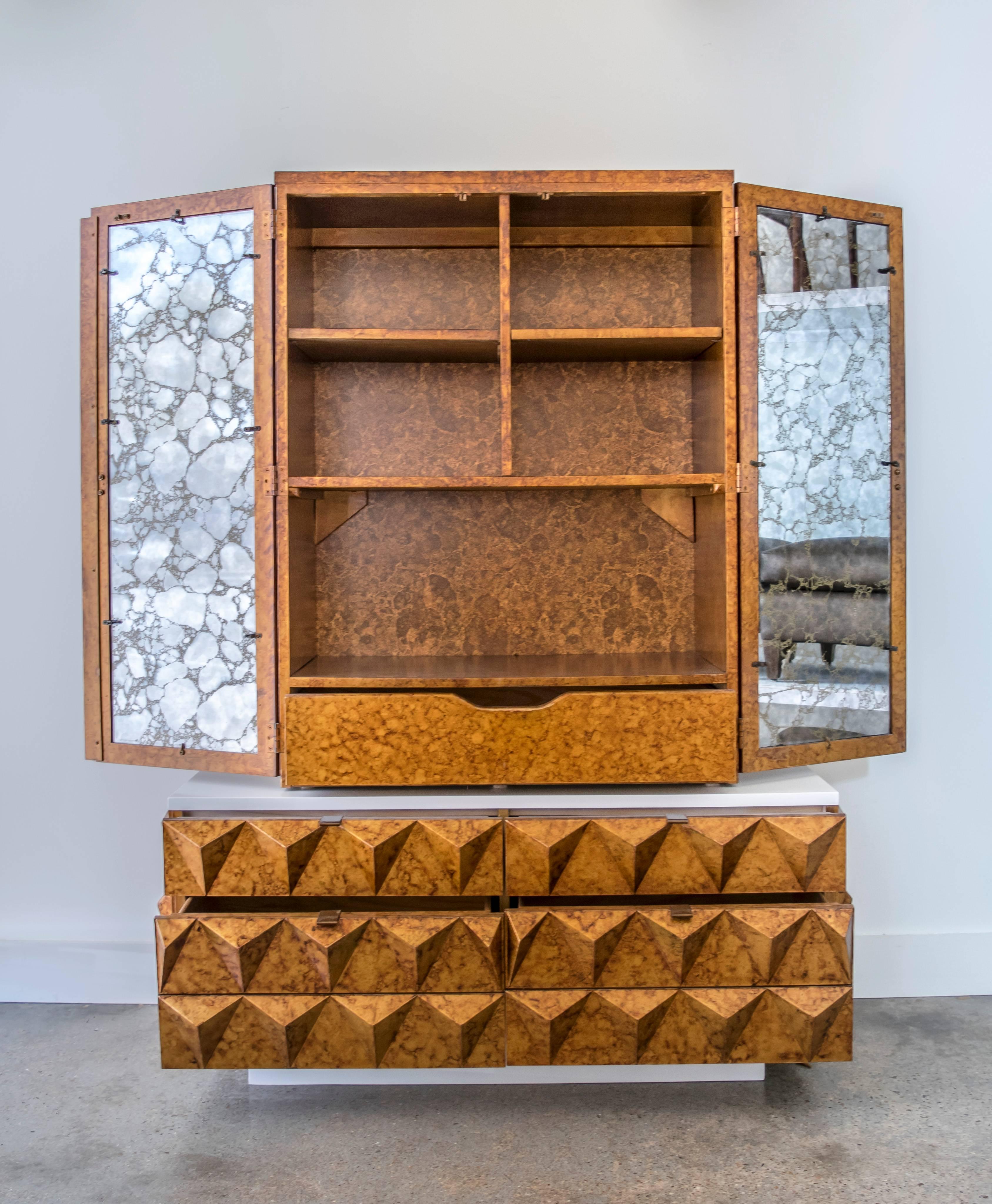 Outstanding Mid-Century Brutalist faux tortoise armoire with diamond shaped reliefs; the base is finished in a matte white lacquer. The armoire is in two pieces and the bottom has three drawers, one top and two are double sized. Inside it has a