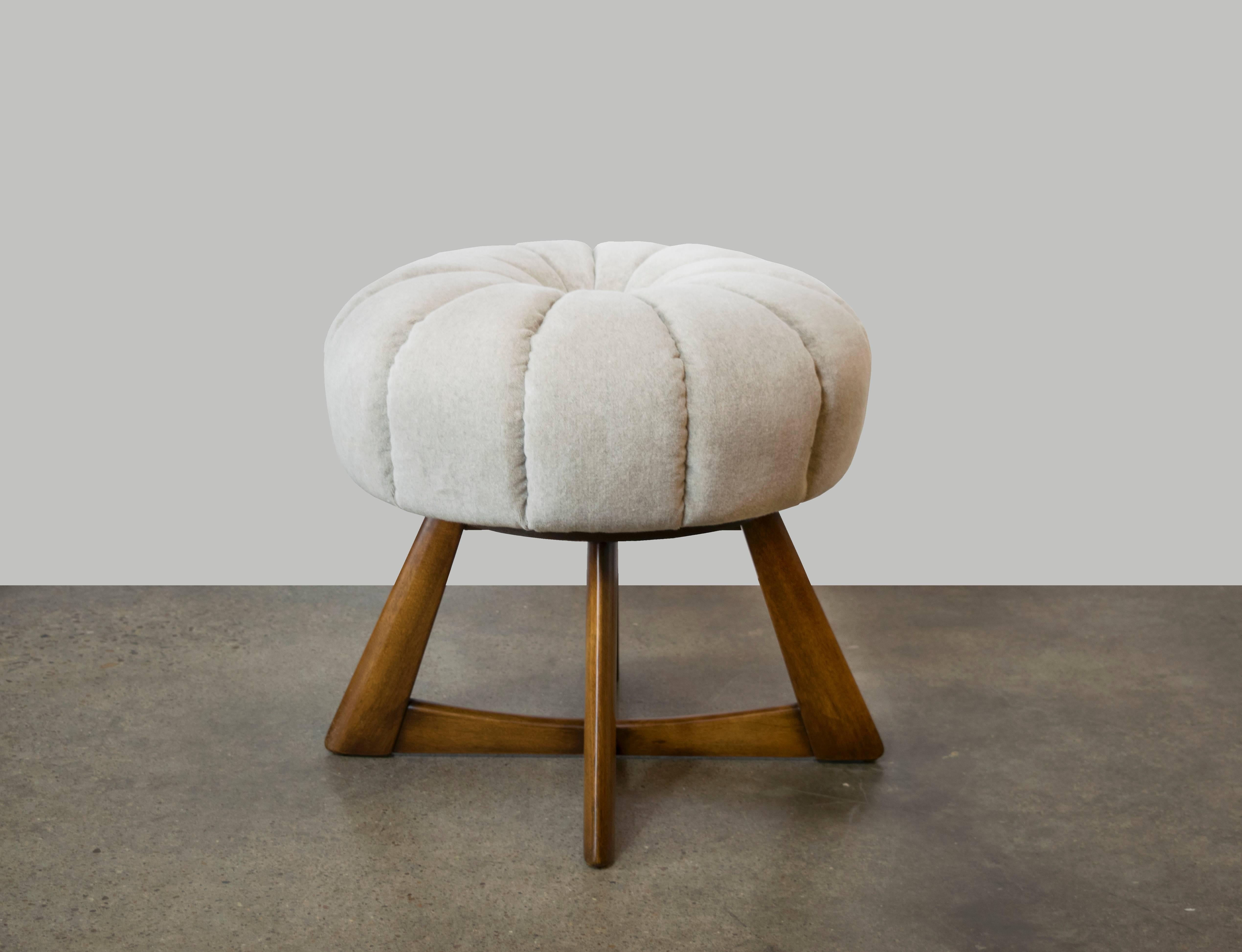 These spectacular Heywood-Wakefield Sculptura poufs never go out of style. With a swivel seat and button tufted pale grey mohair velvet upholstery, this ottoman is able to stand alone and command a space or pair it together with a sofa or chair. 