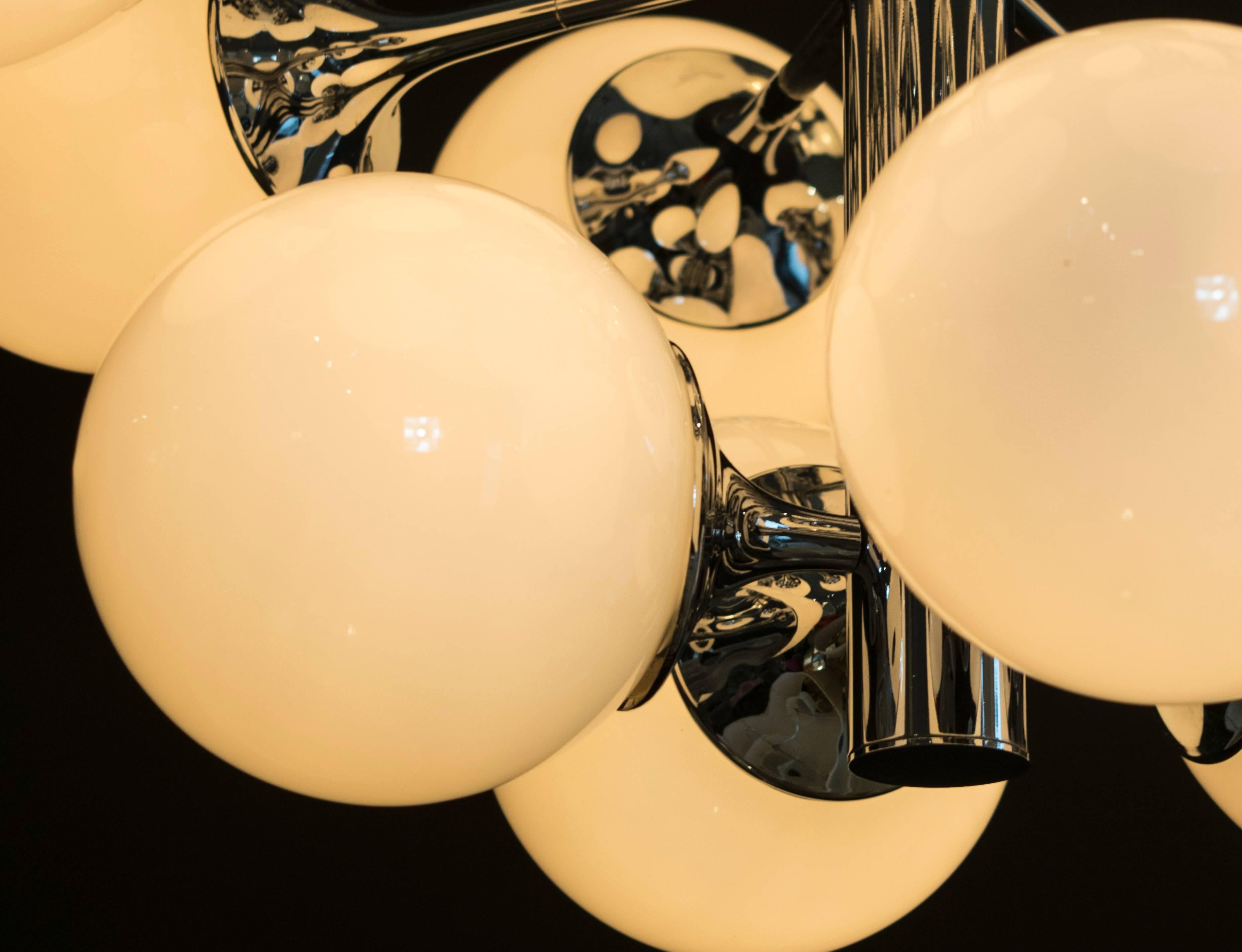 Extraordinary pair of Lightolier 16 globe Sputnik chandeliers with opaque white glass globes. It’s difficult to find pairs of these.
