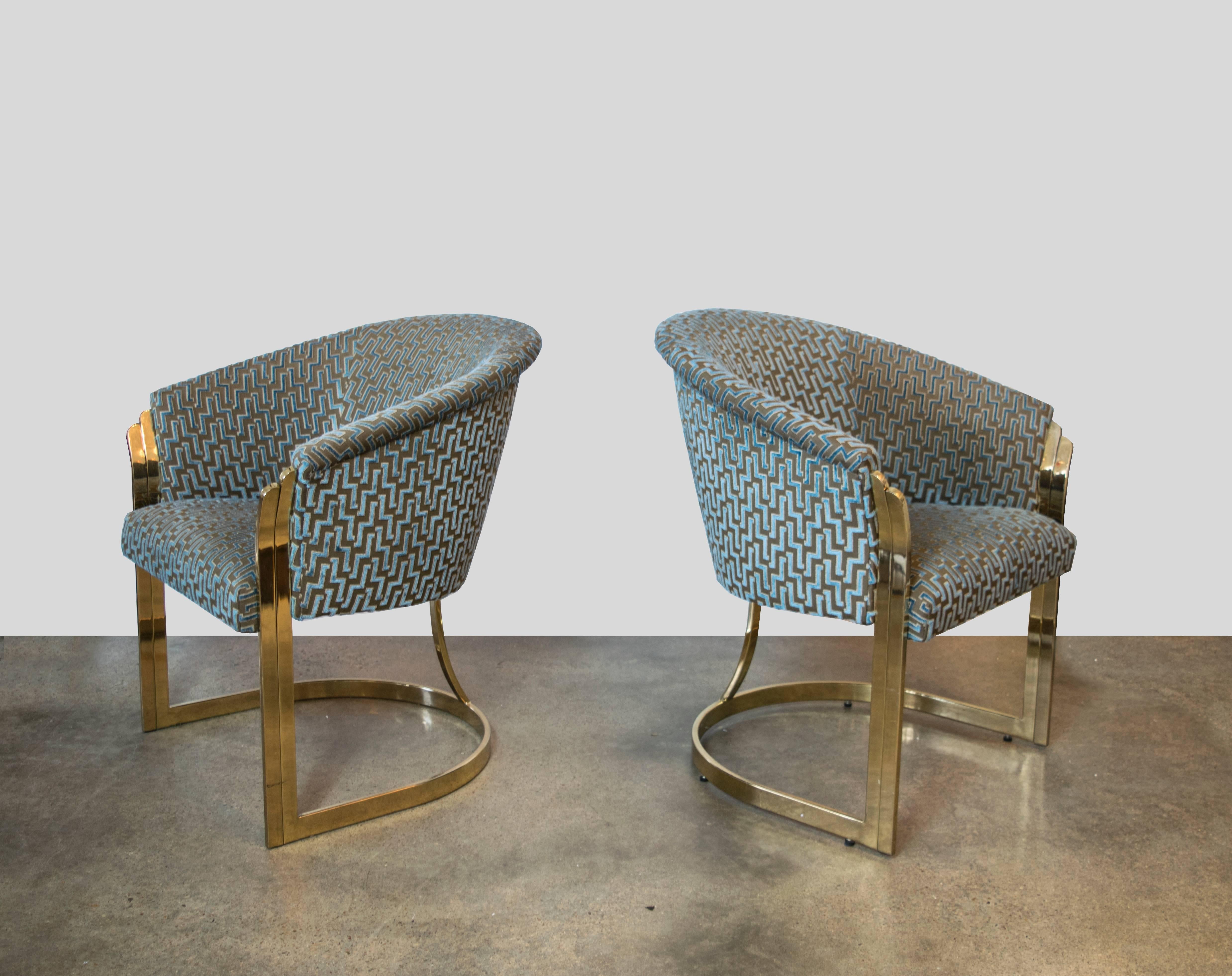 Beautifully sculptured brass chairs with fluted arm rests and a central bar bracing the backrest. Recently upholstered in Brentano teal and taupe cut velvet zig zags. These chairs are absolutely breathtaking in person.