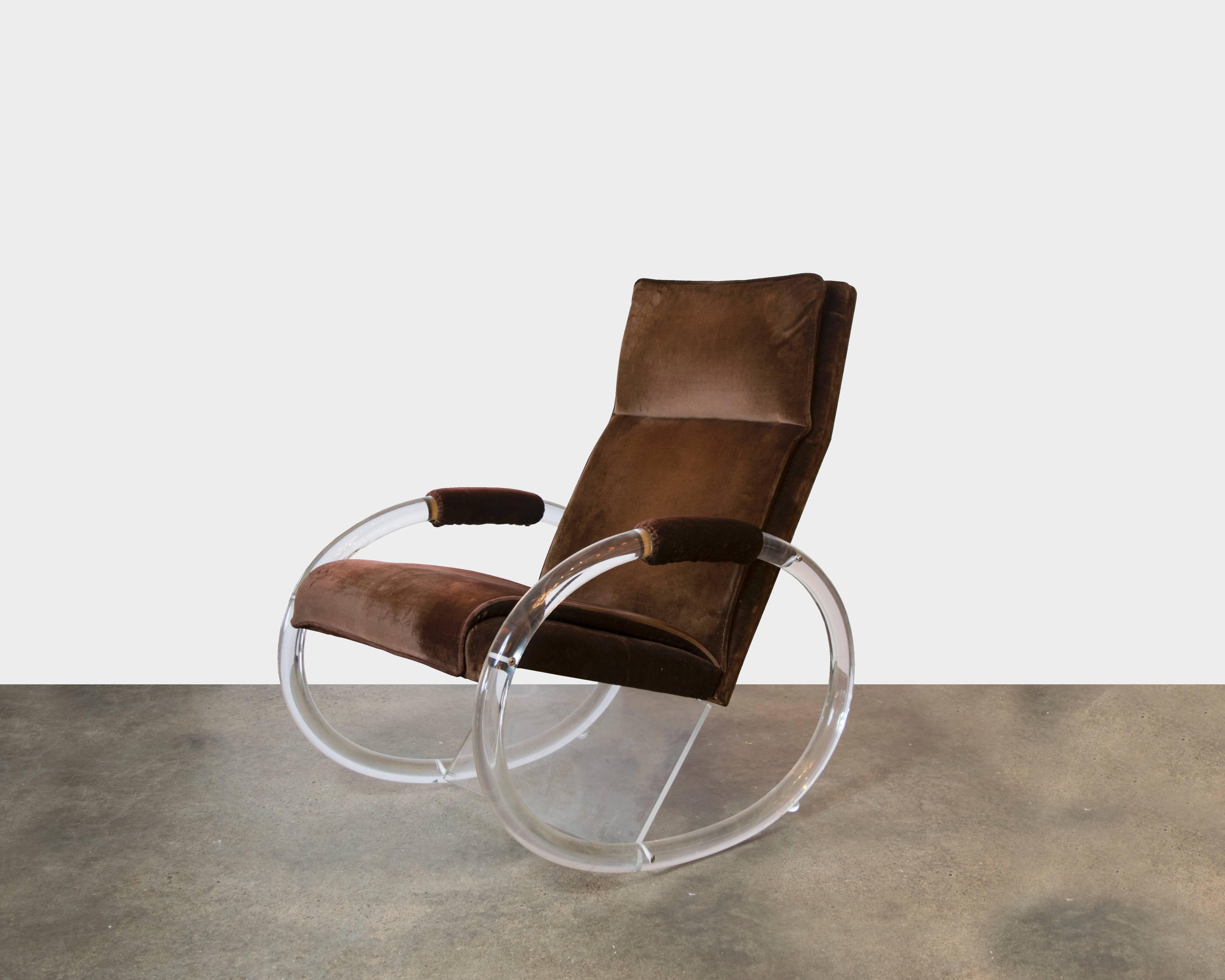 This Lucite rocker by Charles Hollis Jones is perhaps the most fabulous rocker ever made. It sits comfortably and yet is a glamorous addition to a living room, nursery or sun room. Everyone loves a rocking chair! It has the original upholstery which