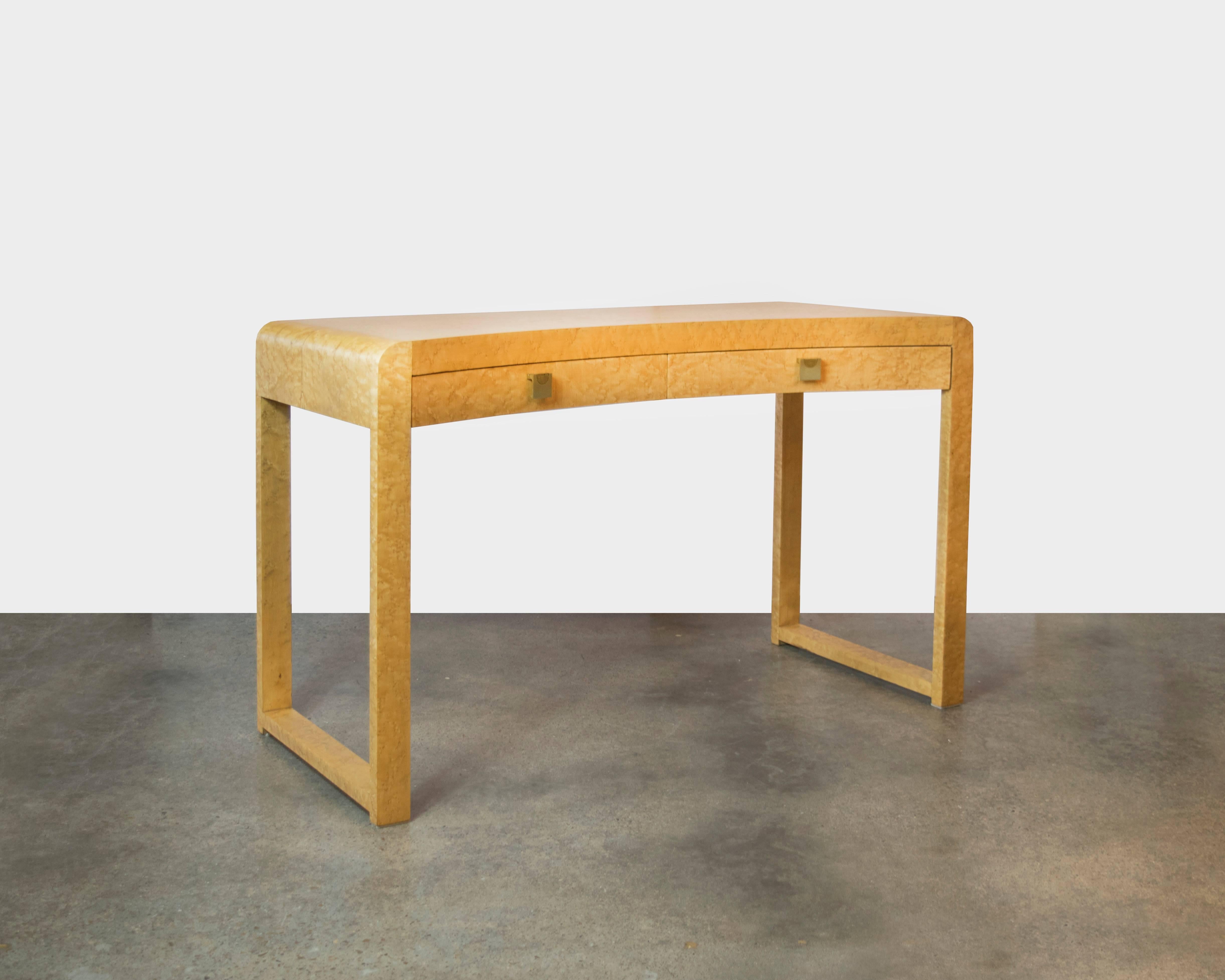 An elegant desk or vanity in the style of Milo Baughman. This piece has a curved front which provides an interesting design detail. The top piece rolls down in a bentwood style eliminating seams on the top of the table. Beautiful detailing in the