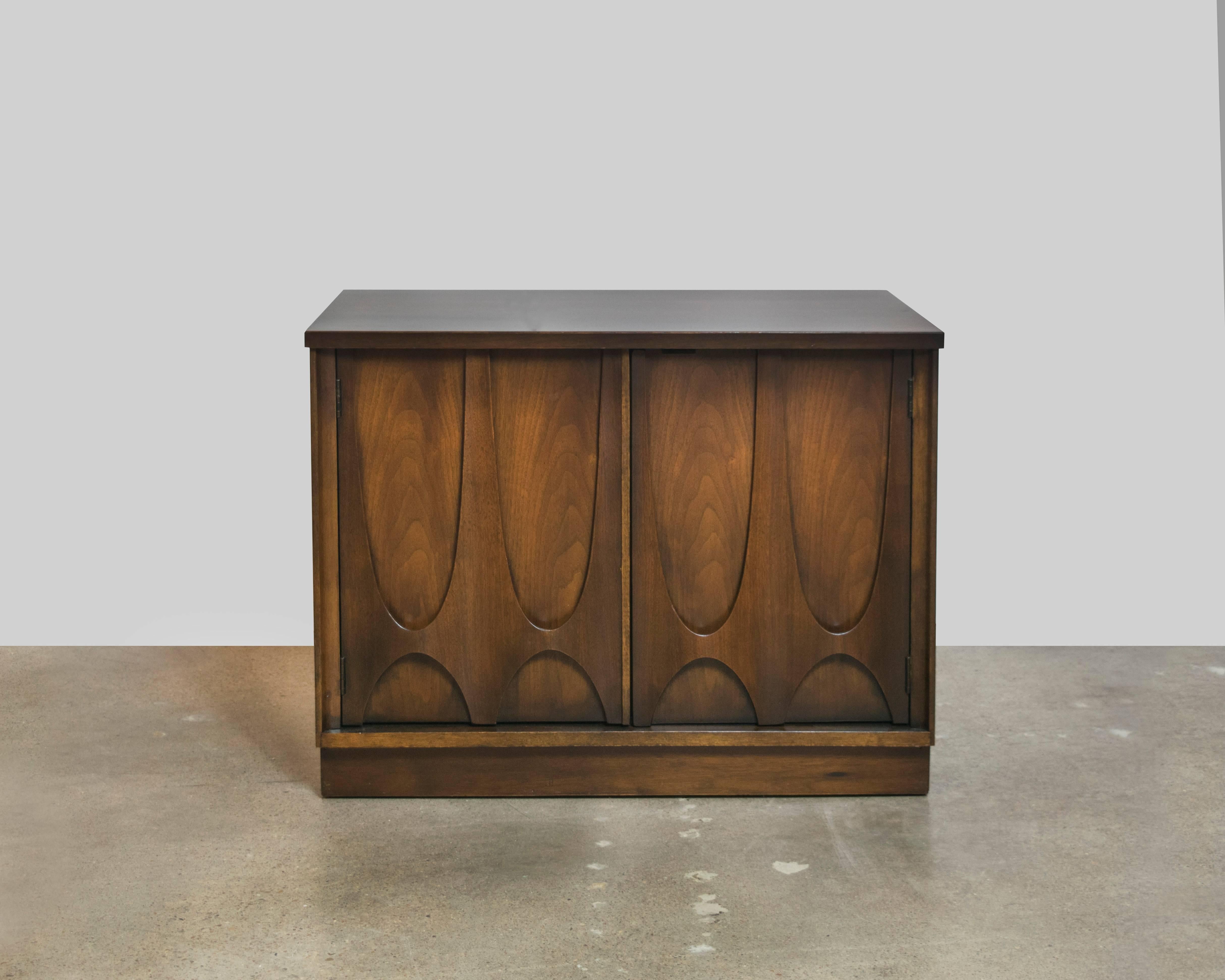 Quintessential Mid-Century Modern at its finest, these Brasilia walnut nightstands or end tables by Broyhill are a prime example of 1950s-1960s Futura design and architecture.
