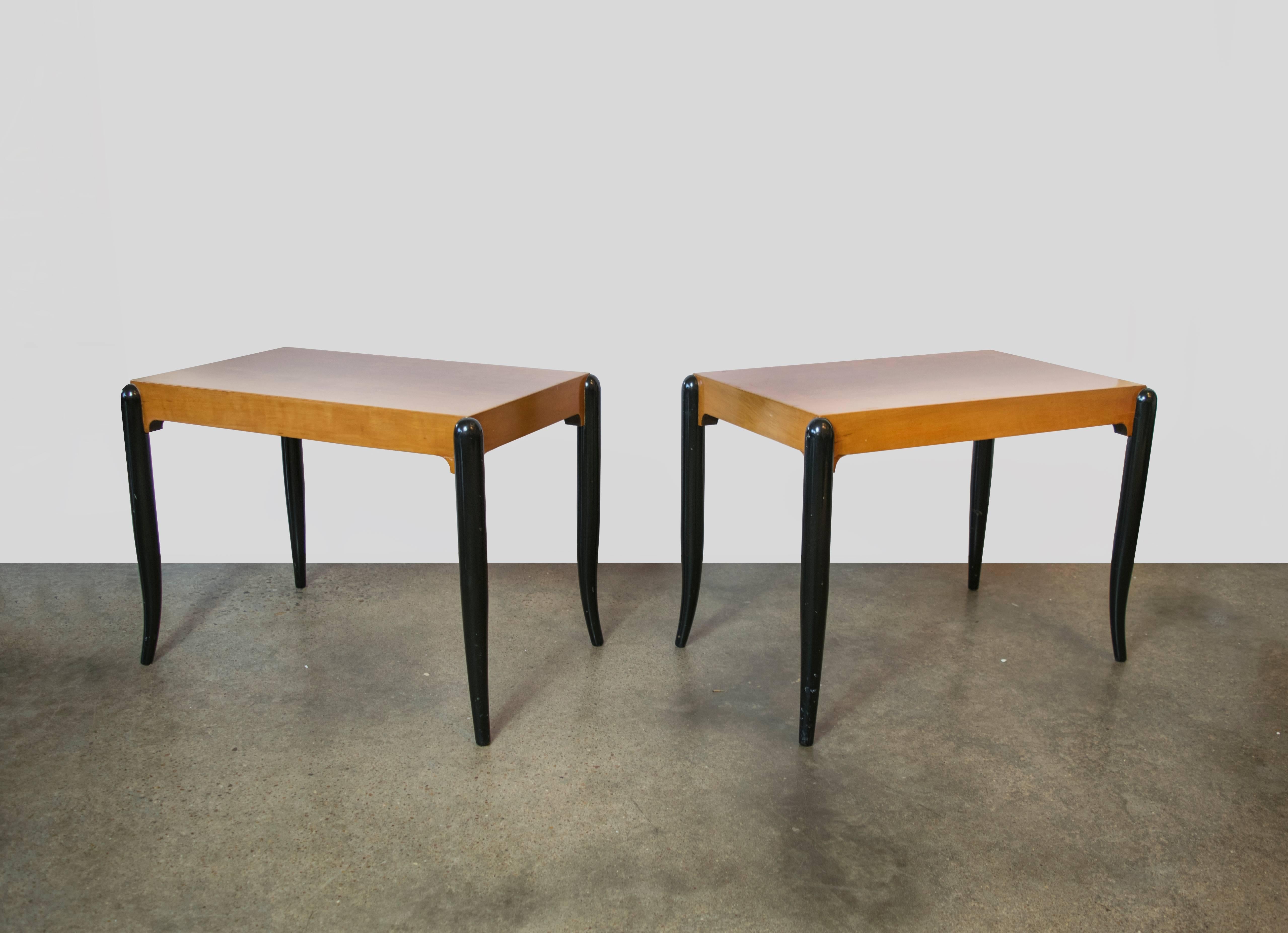 Elegant diminutive French moderne side tables with tapered black lacquer legs and a natural mahogany finish. The tables can be used as is but the legs could use refinishing.