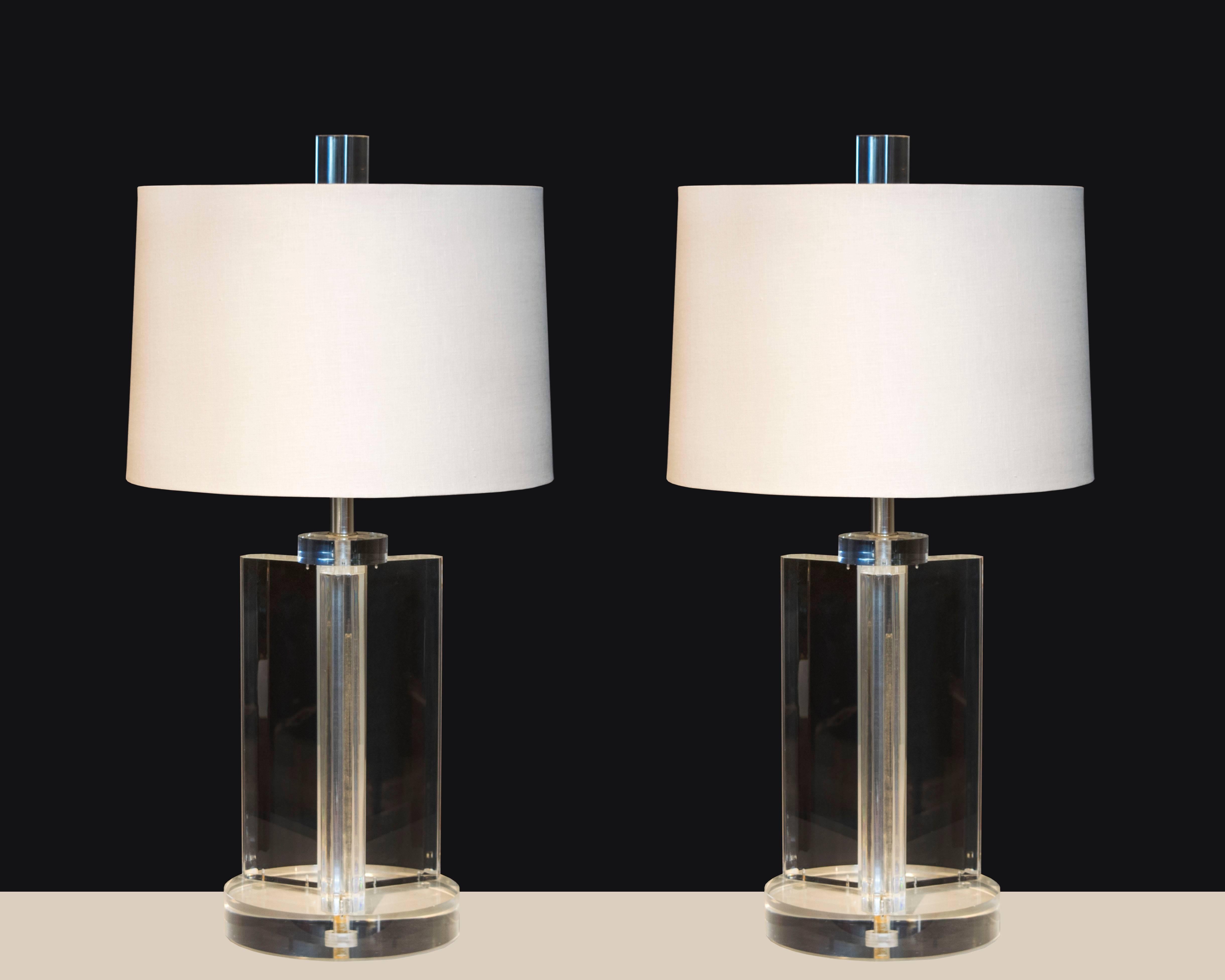Absolutely stunning pair of Lucite lamps with a Y-shaped column sitting on top of a circular base with oversized matching finials. These lamps are not signed but they are some of the best constructed vintage Lucite lamps we've seen yet.