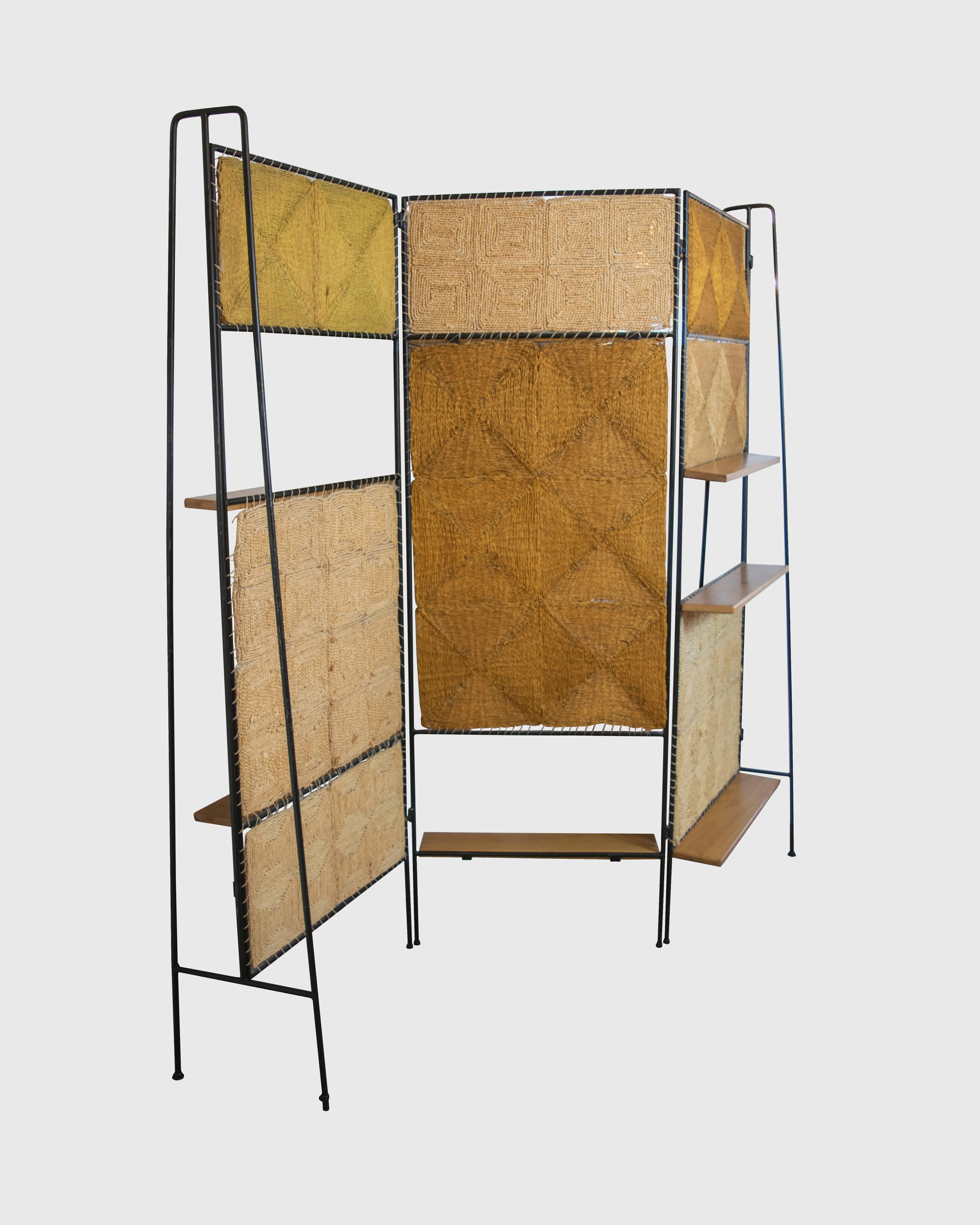 This is an extraordinary and rare tri-fold wrought iron screen with amazing hand detailing and patterning within the woven screen panels. We do not know who the designer was of this fantastic screen, it looks a bit like Frederick Weinberg or Arthur