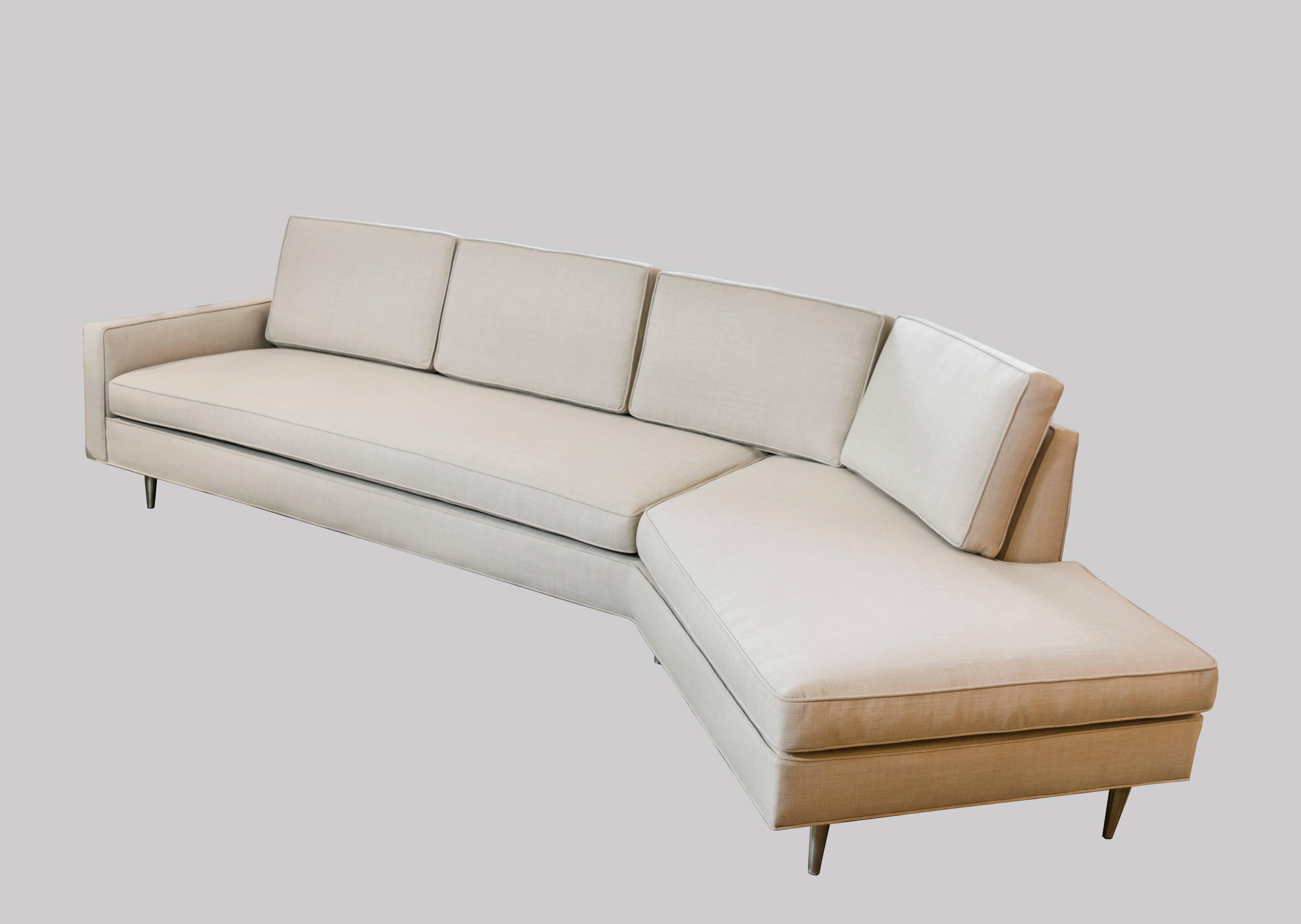 This sofa is absolutely breath-taking in person and has been recently upholstered in a high end natural linen. The sofa is signature Harvey Probber style with the surprise of the angle at one end of the couch and the traditional armrest at the other