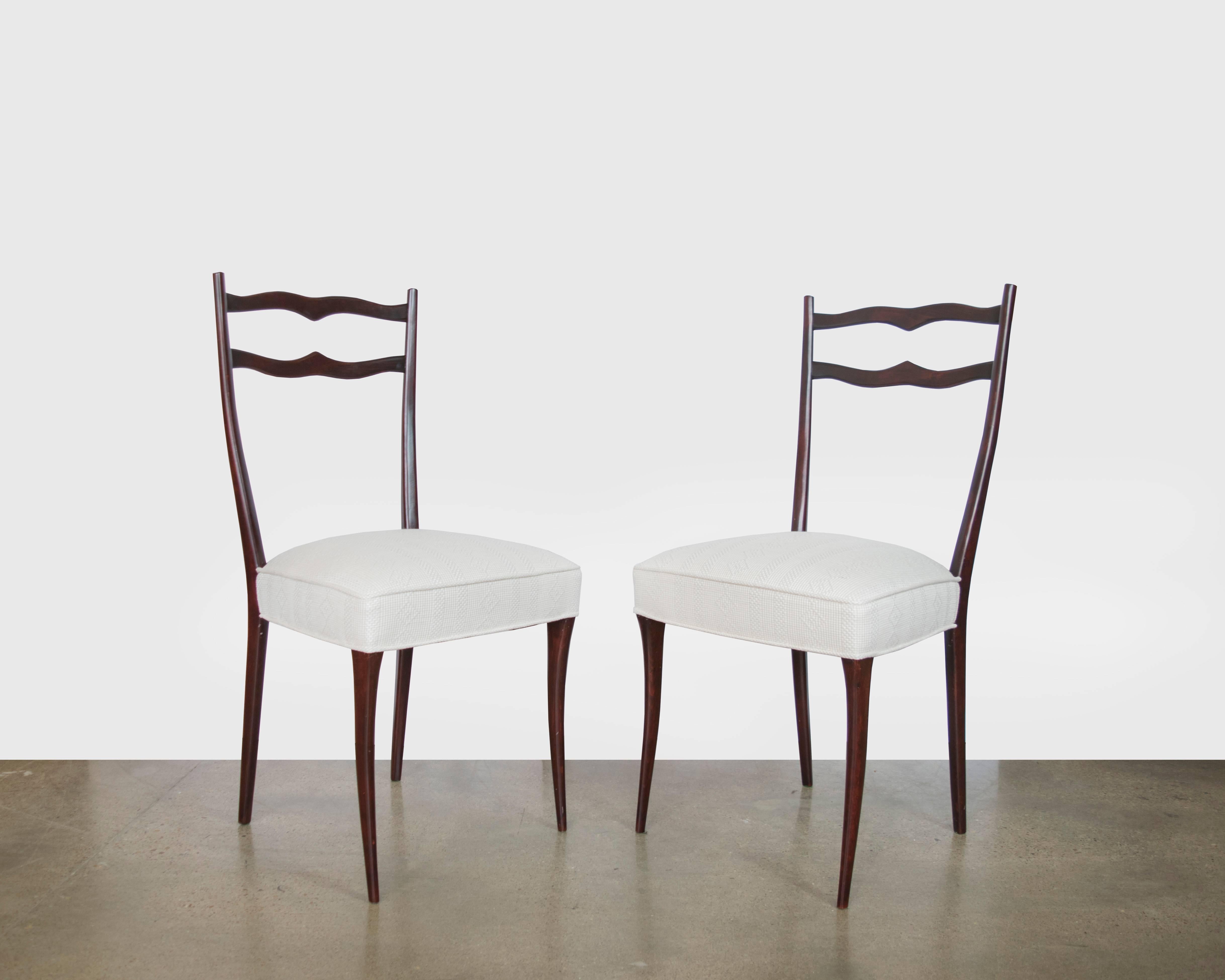 A graceful set of six dining chairs from Italy, made in the 1950s and thought to be designed by Ico Parisi. The chairs are mahogany; the seats are newly upholstered in Knoll Djenge fabric, colorway salt.