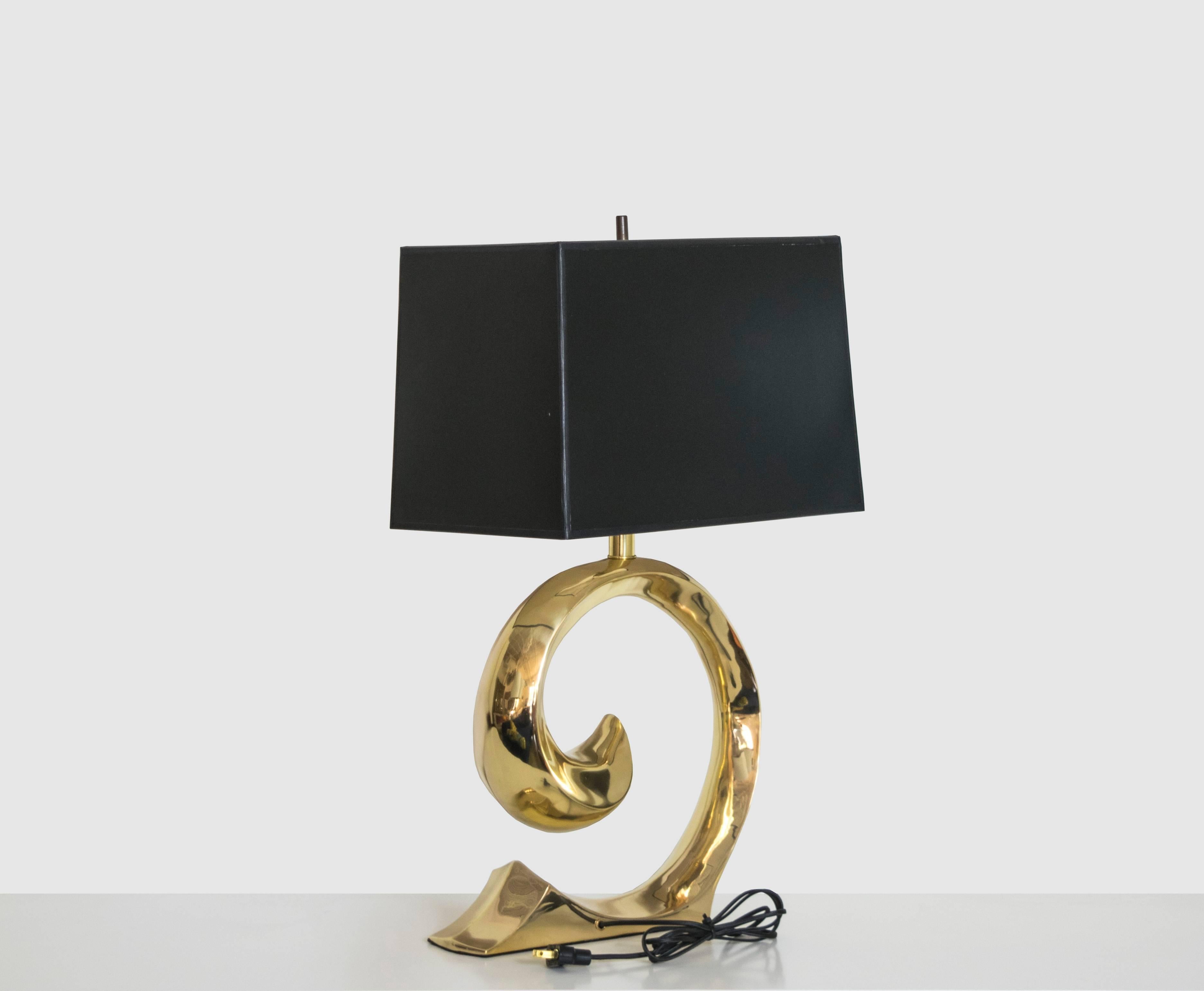 Exquisite pair of very solid and well-constructed brass lamps with the Pierre Cardin signature curve. These lamps have been recently polished and are in pristine condition. Would look great in any interior, whether traditional or contemporary.