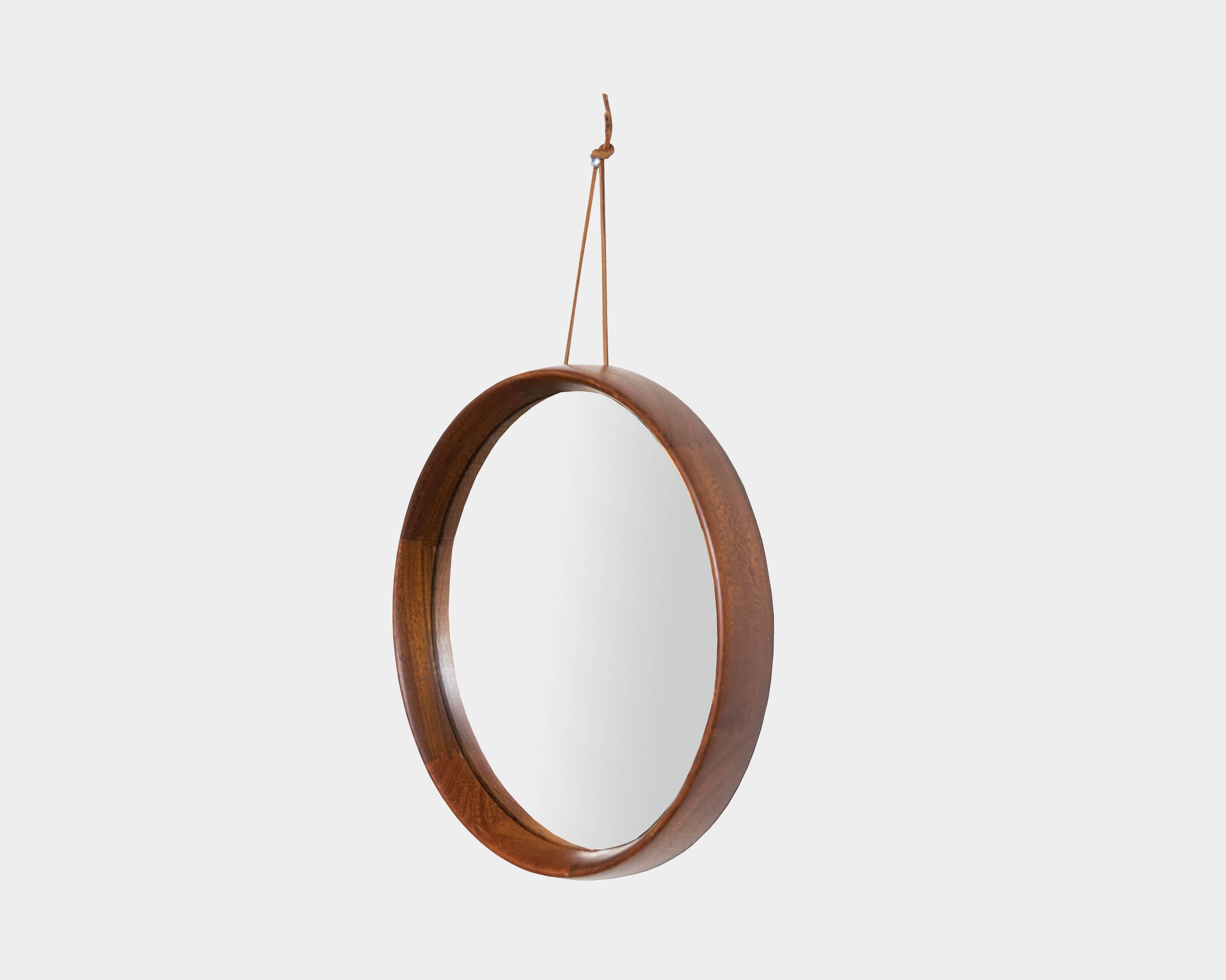 Mid-Century Modern rosewood round mirror with leather hanging strap.