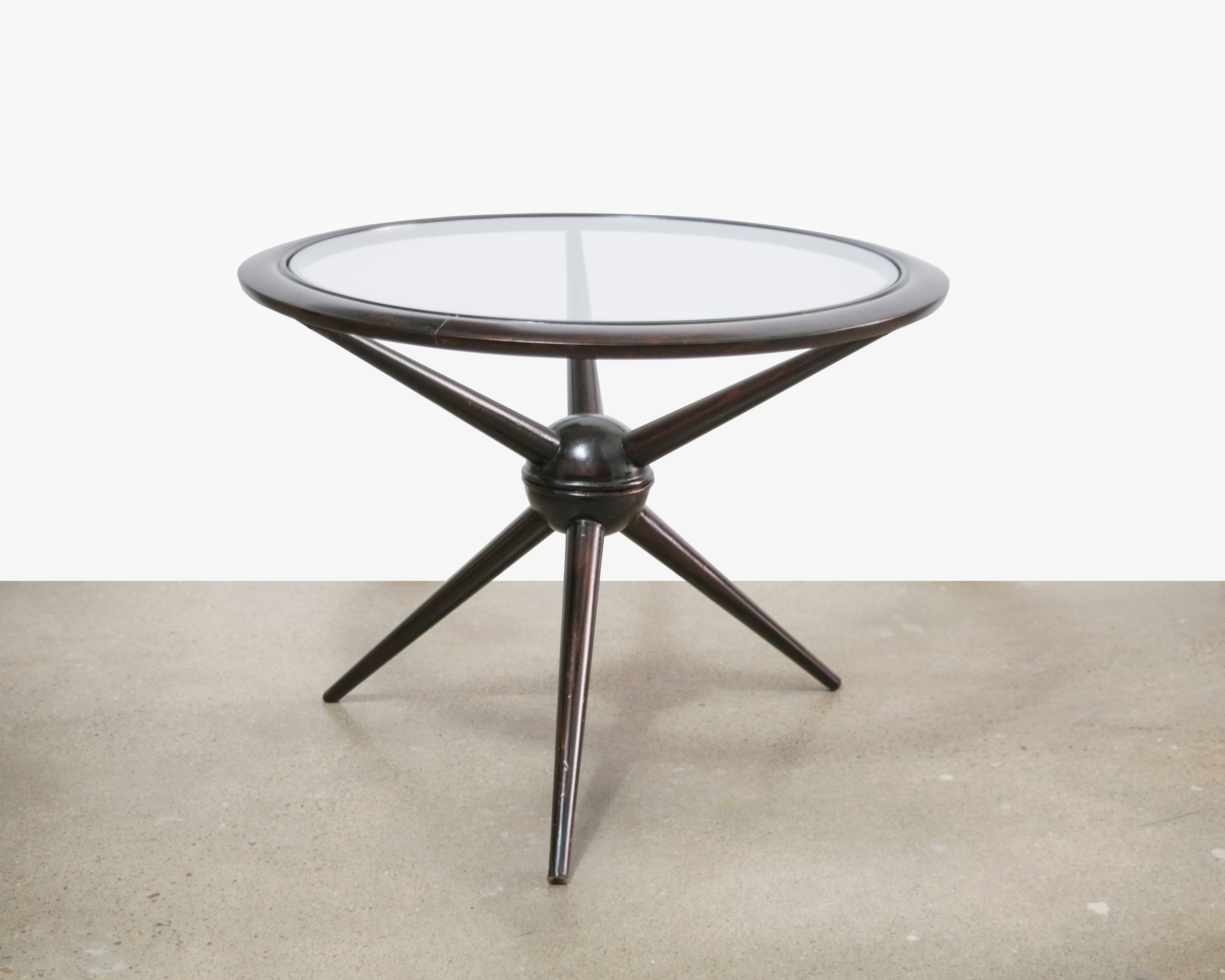 A beautiful little side table by renowned Italian designer Cesare Lacca from the 1950s. It has a center orbit held by three legs and three arms.