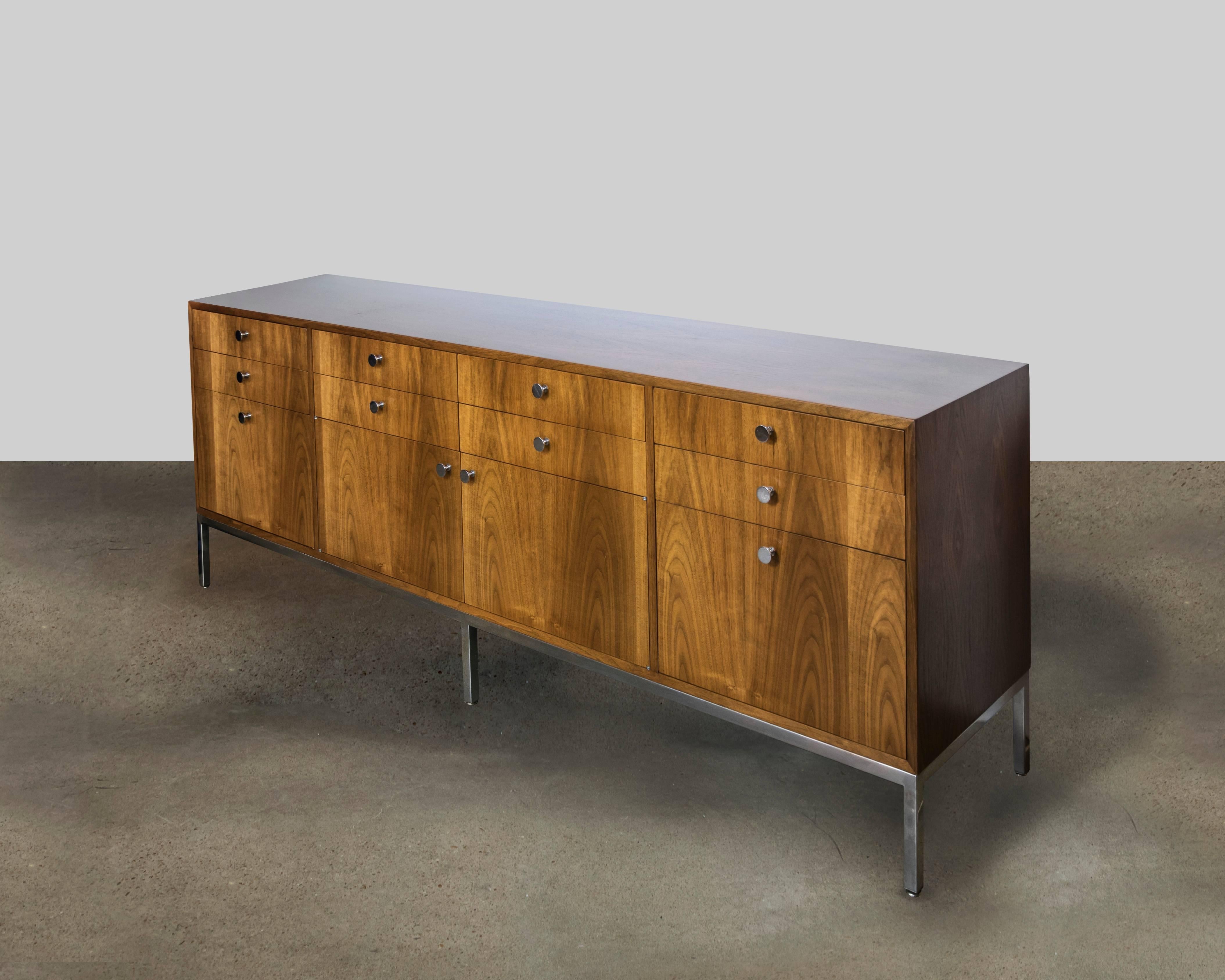 This is such a beautiful credenza by Pace Furniture Company and was manufactured in the 1960s. It is extremely well-made with a chrome base and matching hardware. The finish is a warm honey color. It has eight small drawers, two large drawers and a