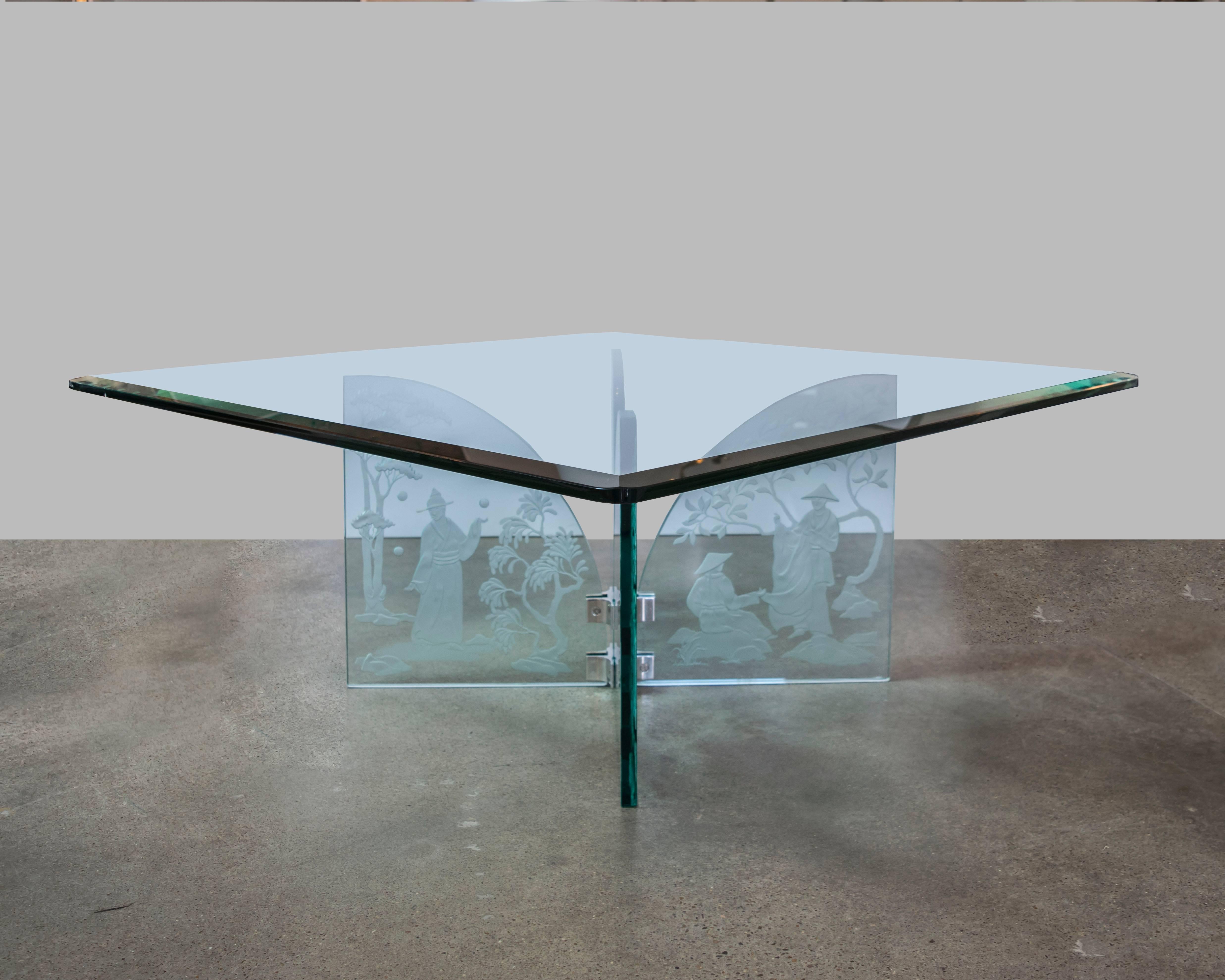 This exquisitely crafted four-panel glass coffee table came from a fabulous estate filled with original Karl Springer furniture. We were informed that the table was purchased from the Karl Springer showroom and the four-panel base was hand etched by
