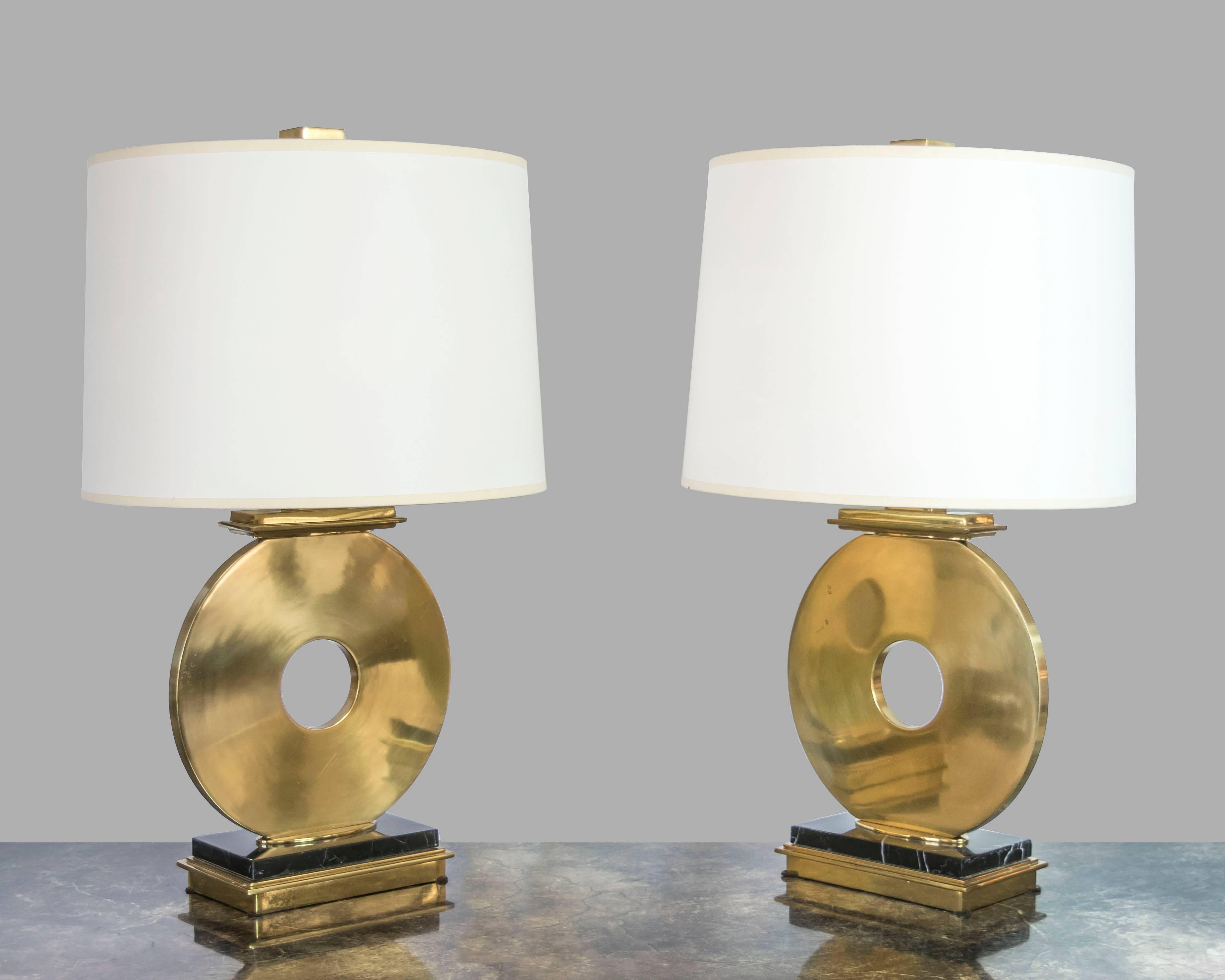 This is a really cool pair of 1970s table lamps with thick brass circular 