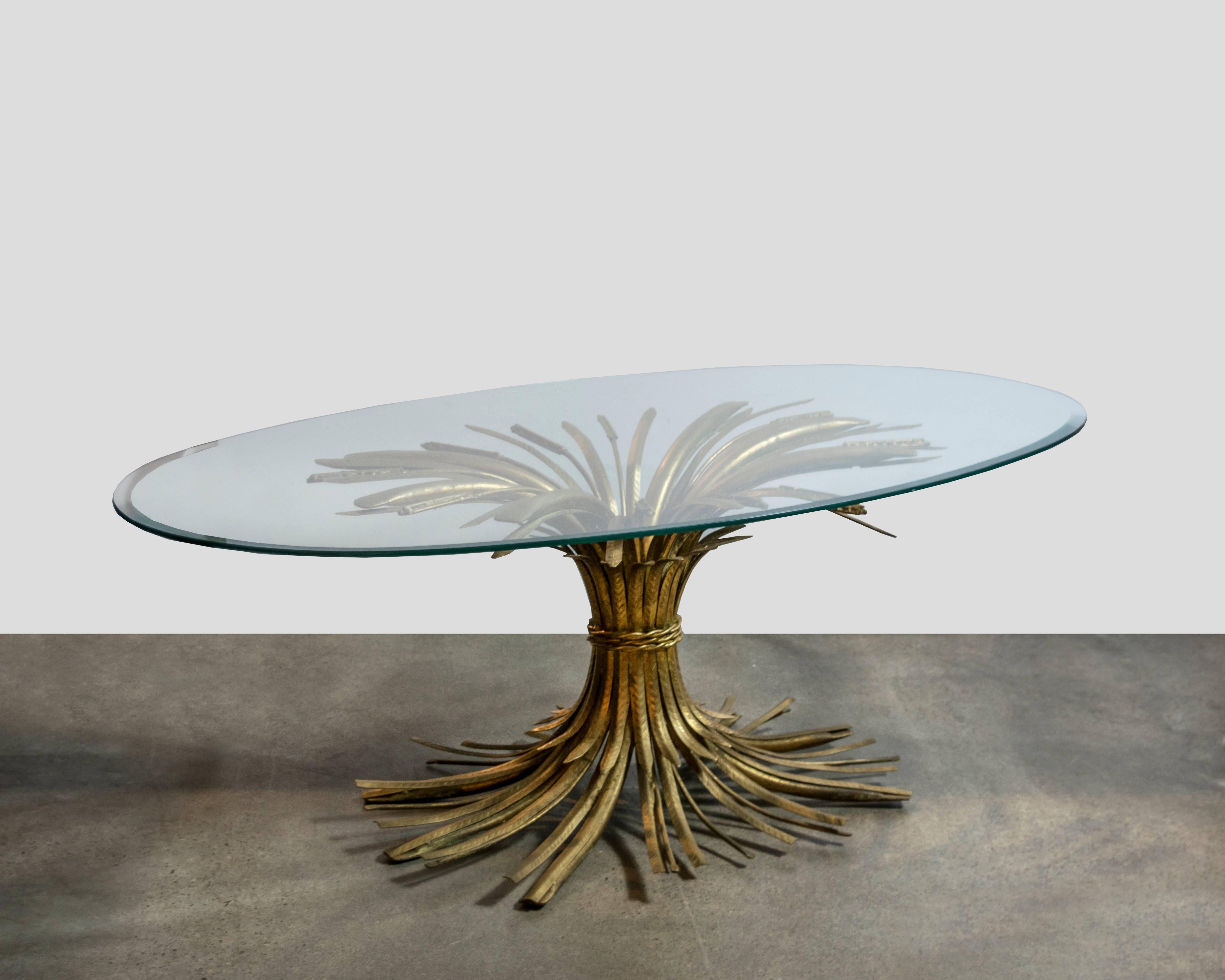 Superbly made brass wheat sheaf table with remarkable detailing in the wheat tips and in the patterning within the sheaves themselves. It also has a triple braided decorative cord that surrounds the middle of the base. With beveled glass, an