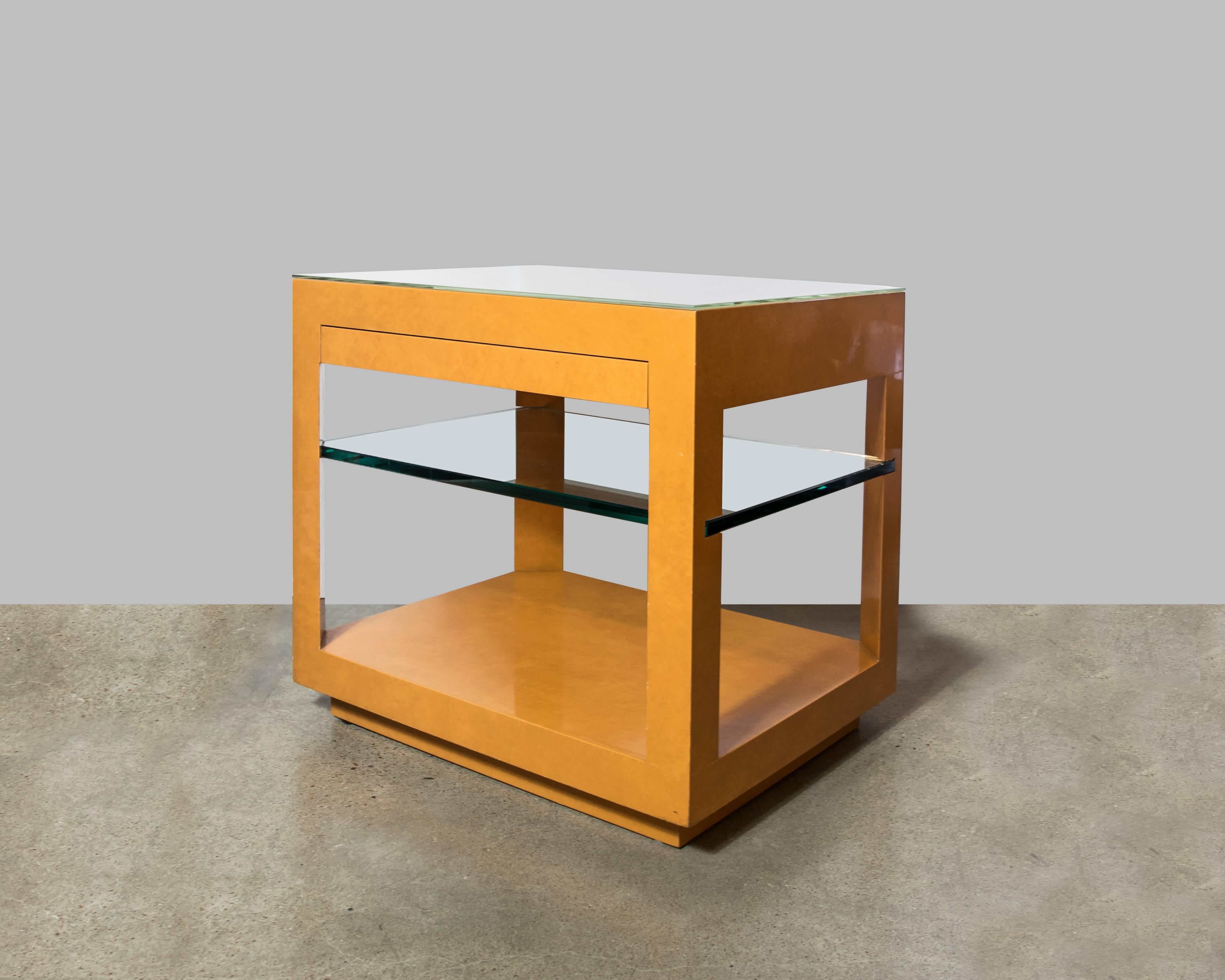 Exquisite oversized single side table in the style of Karl Springer with a single drawer and a one inch thick glass shelf. Very well-made, with a few minor scuffs here and there.
